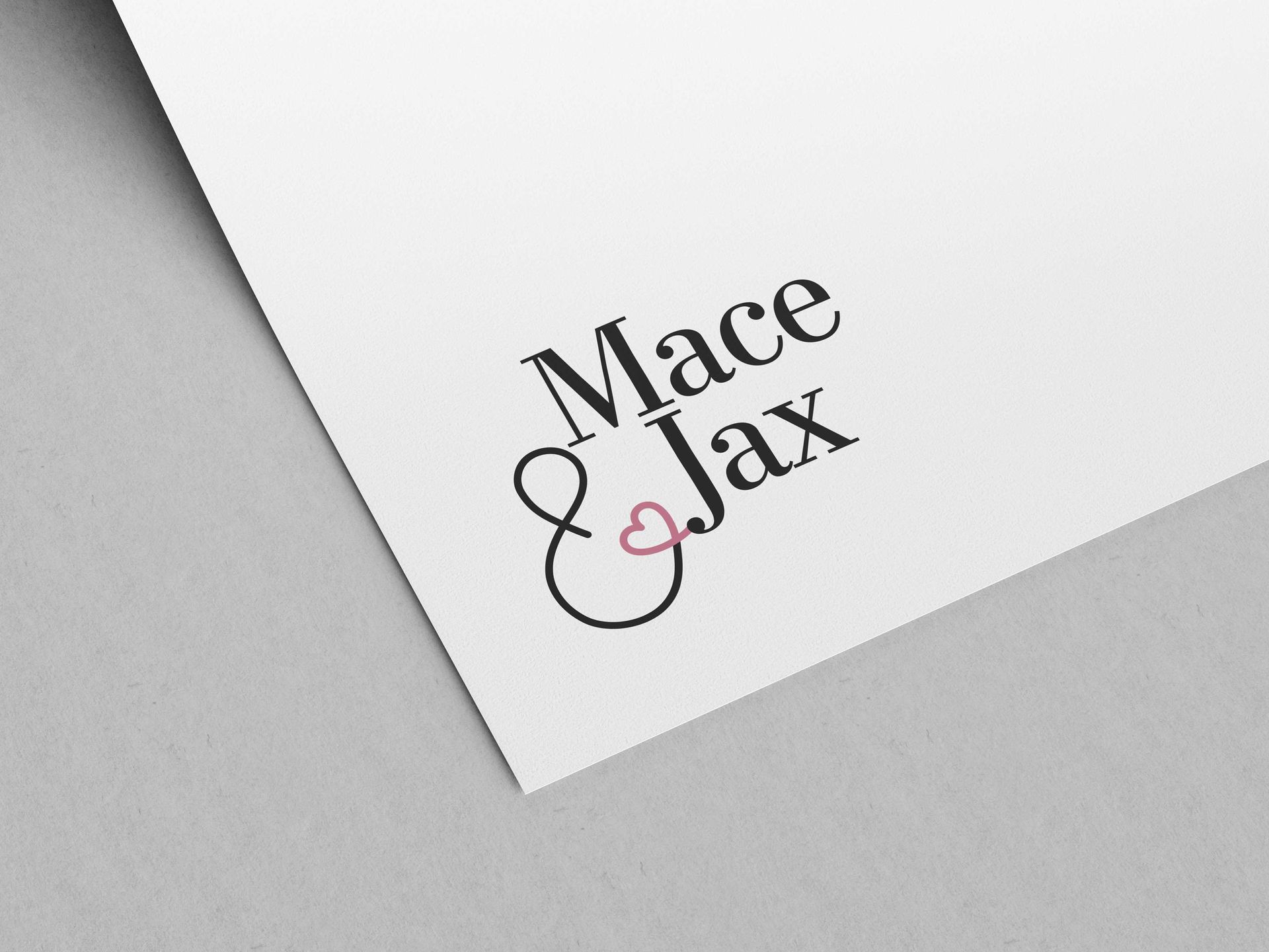 “Mace & Jax” logo on a white tilted card with black and pink lettering