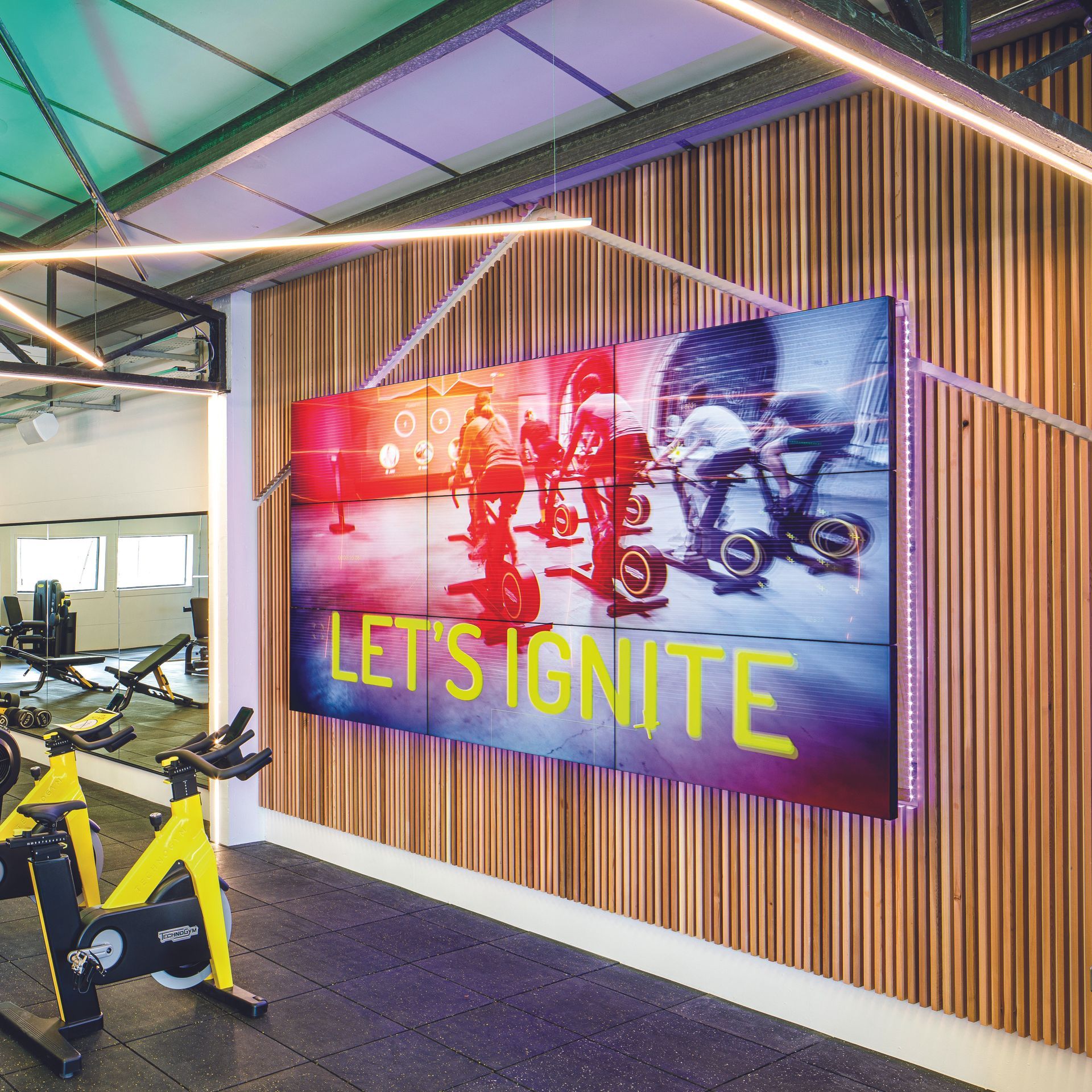 Gym interior with a large screen displaying