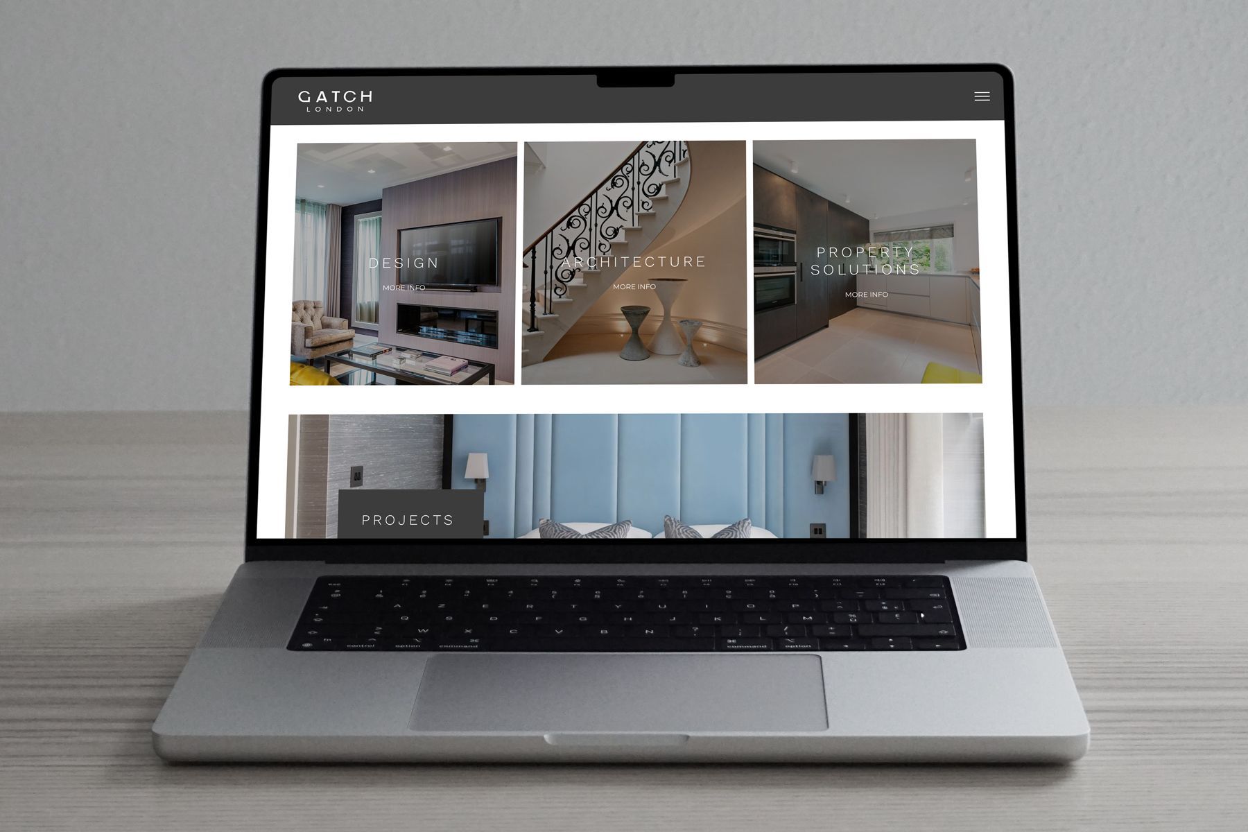 Laptop displaying a website with interior design images.