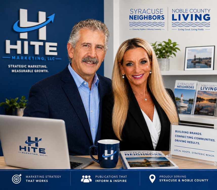 Hite marketing booth with two smiling professionals, blue branding, laptop, and brochures at a trade show.