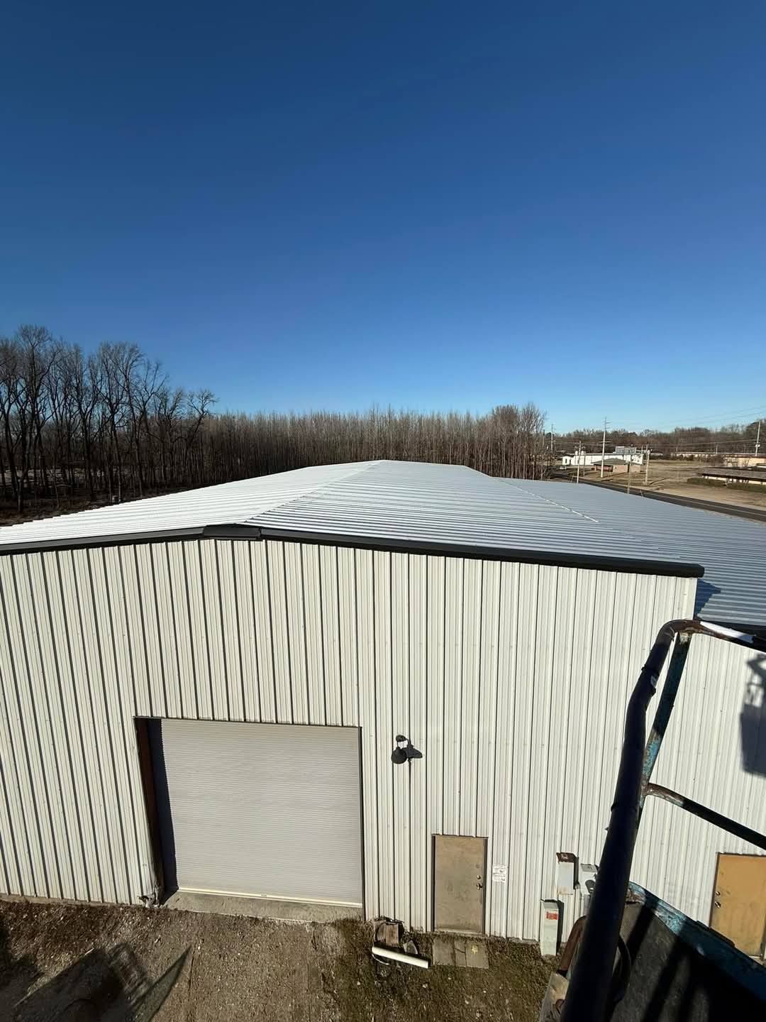 A large white building with a roof that is covered in snow.
