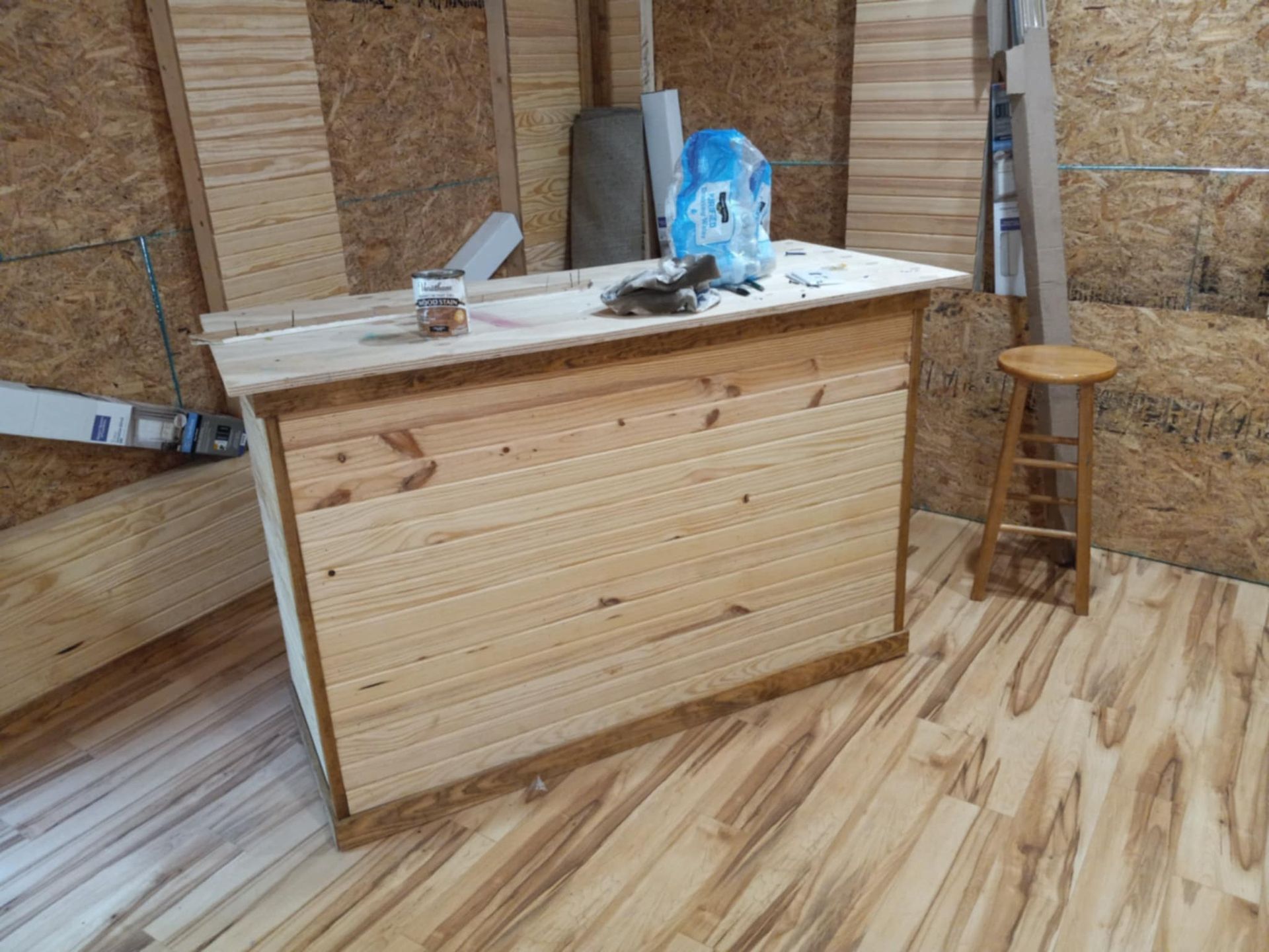 Wooden bar in a workshop with a stool.