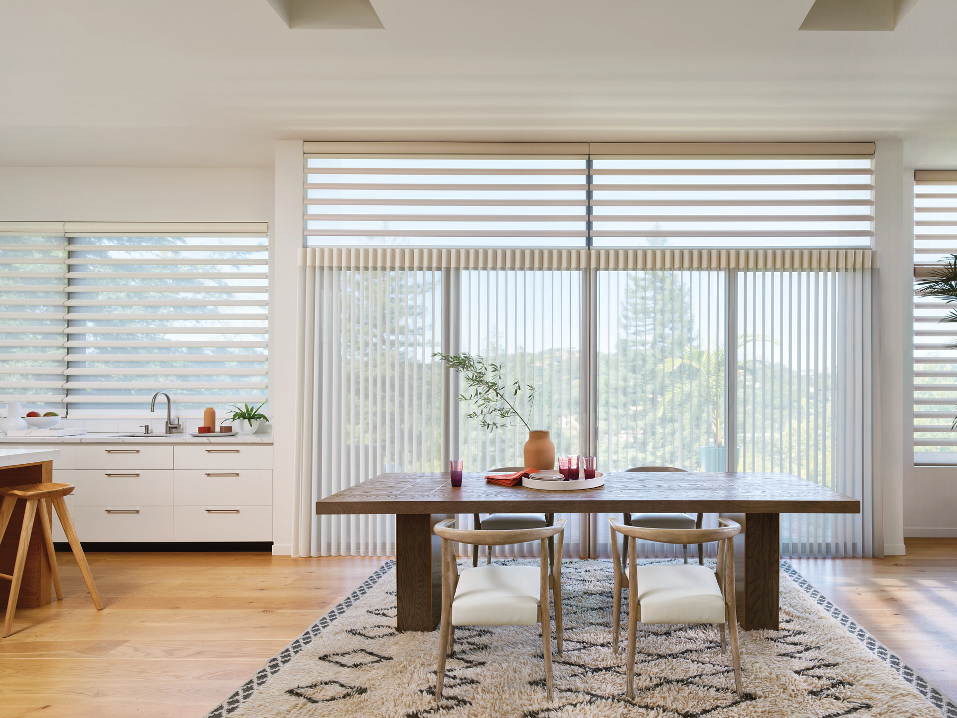 Hunter Douglas shades as soft window treatments on kitchen windows and a sliding glass door