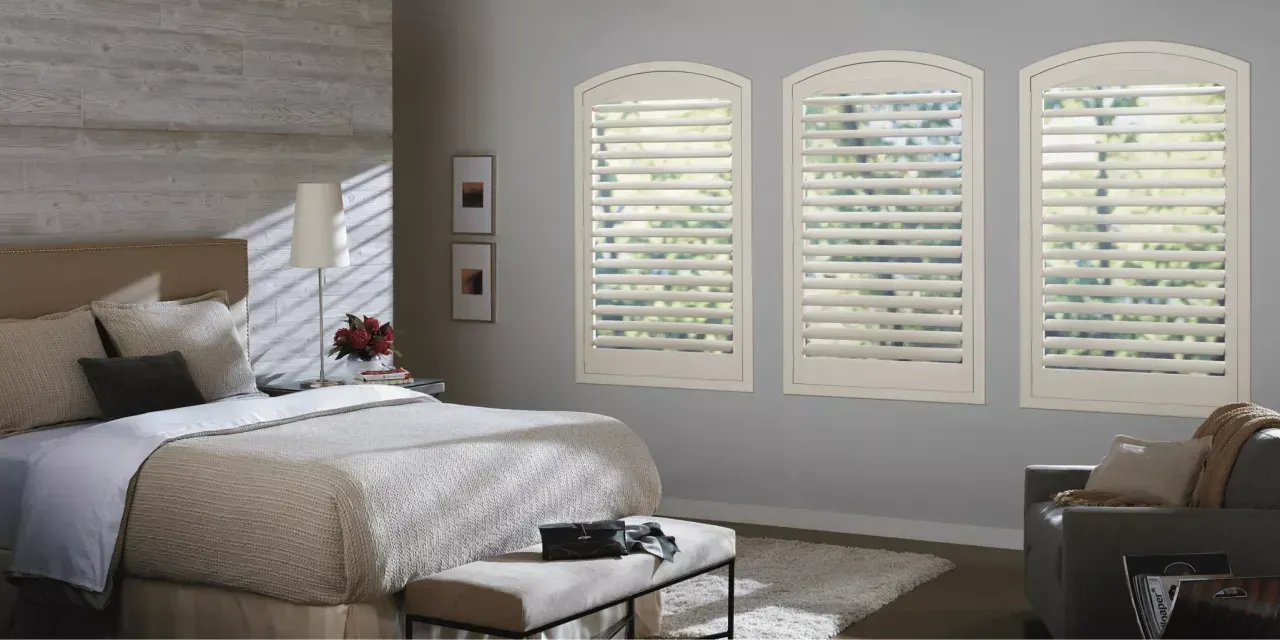 Hunter Douglas NewStyle® Hybrid Shutters in a gray and blue bedroom
