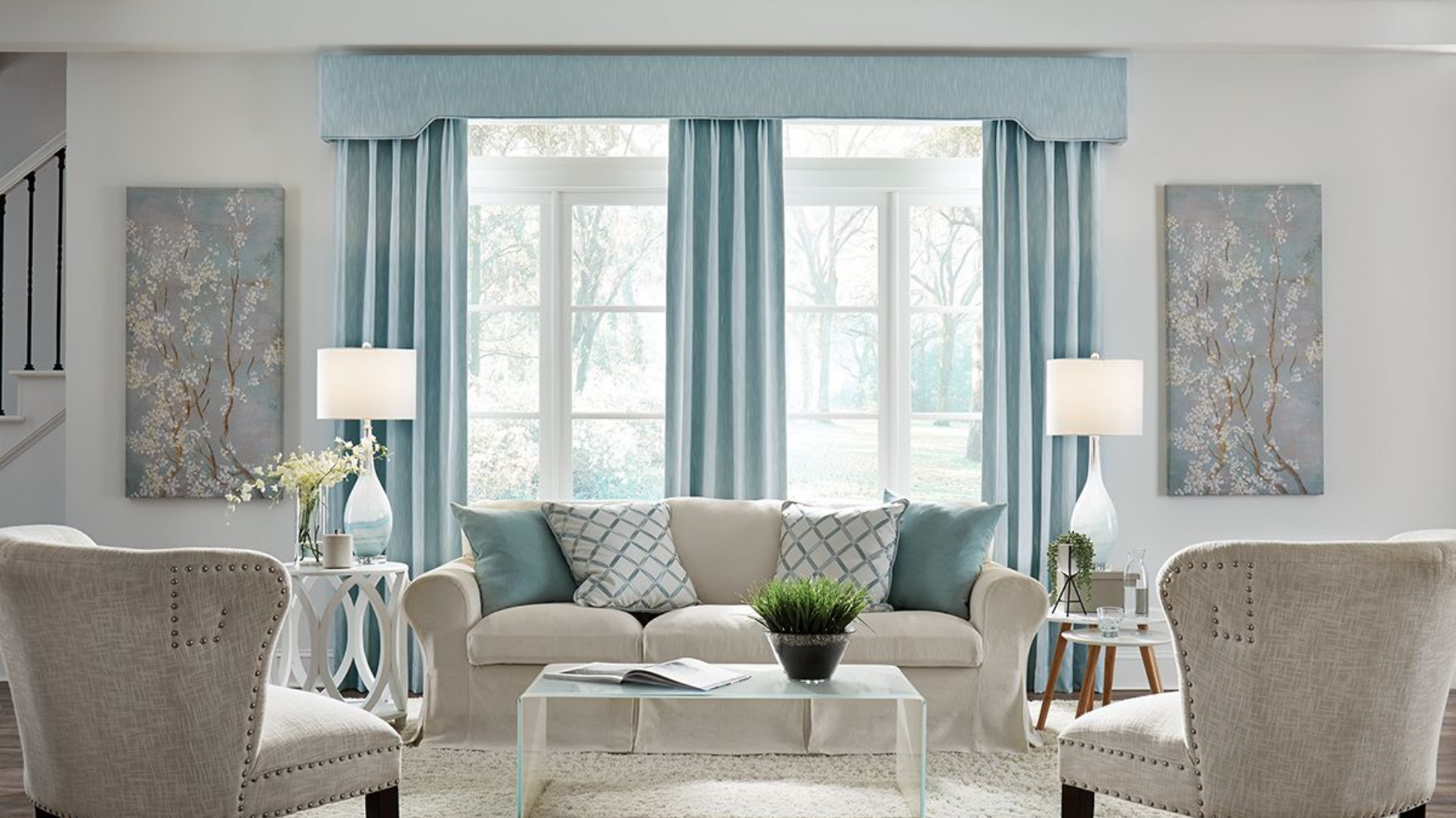 Living room with light blue curtains, matching valance, and two windows.