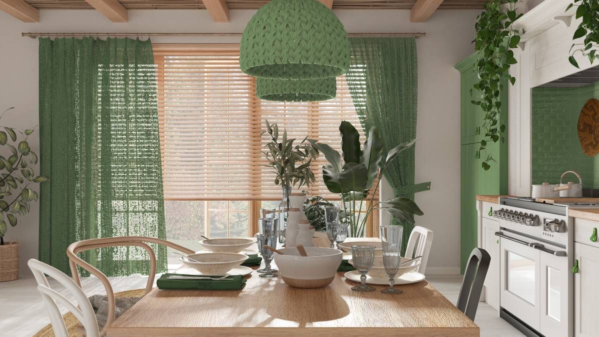 Scandinavian boho interior design with a wood dining table, pendant lamps, and window blinds near Ocean City, MD
