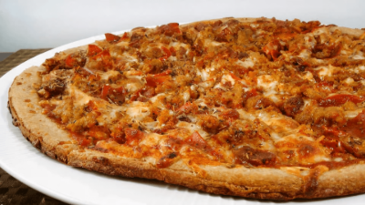 Cheese and sausage pizza on a white plate