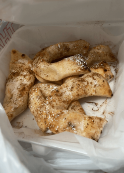 Seasoned cooked mushroom slices in a white takeout container