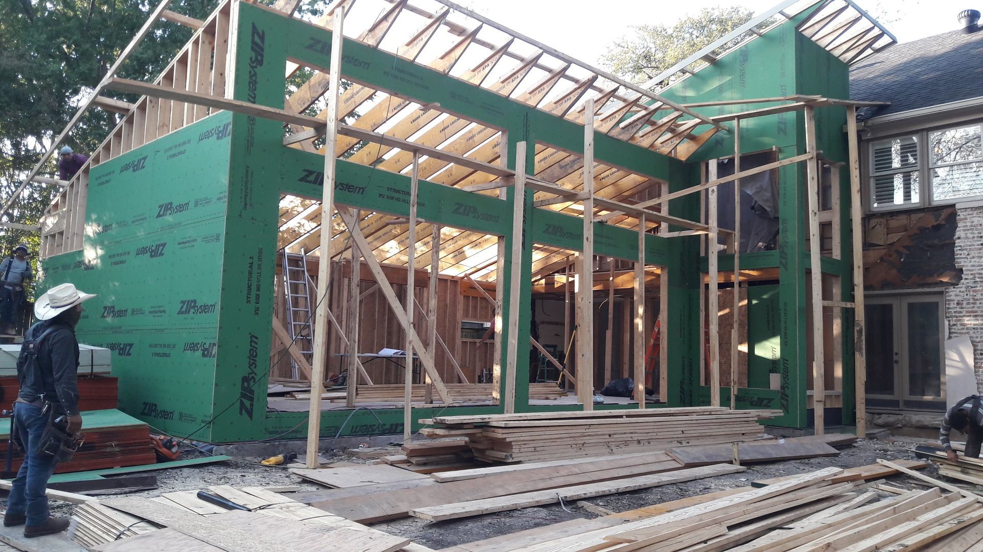 A man is standing in front of a building under construction.