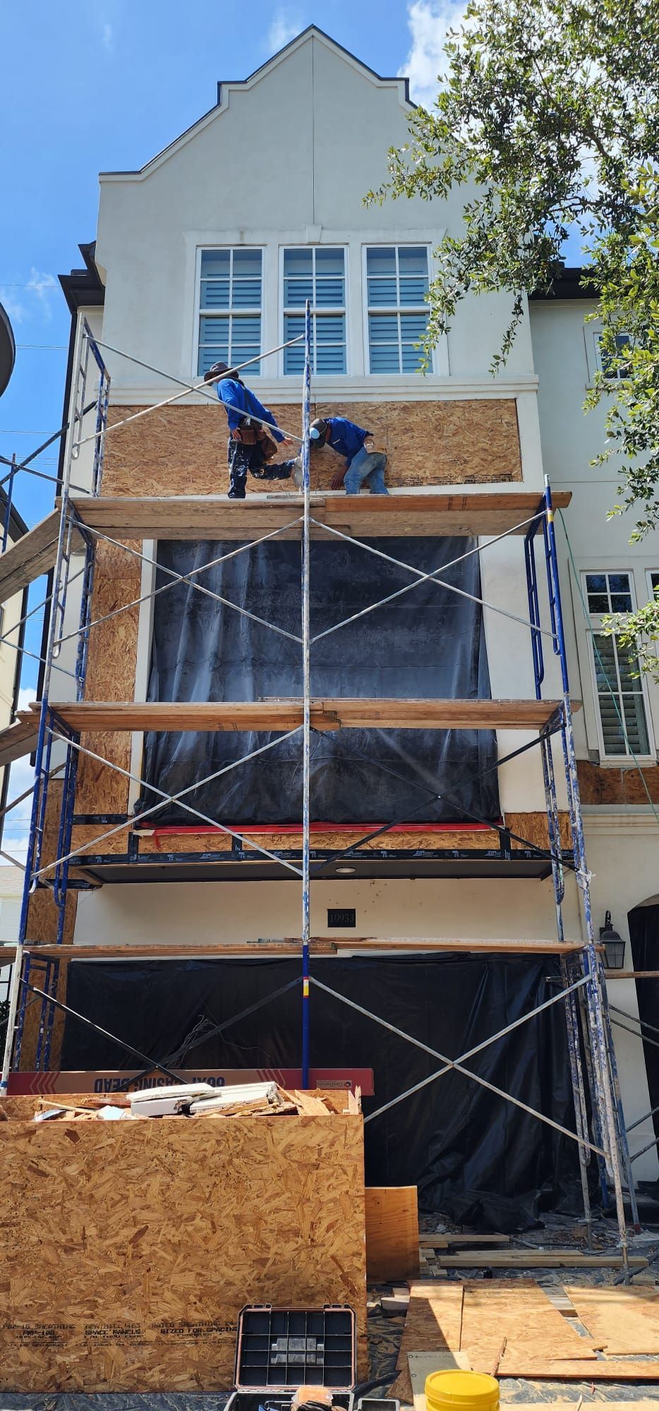 A house is being remodeled with scaffolding around it.