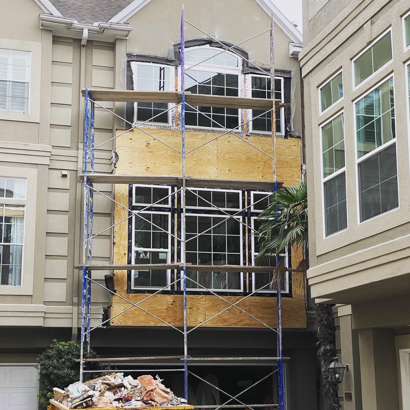 A house is being remodeled with scaffolding around it
