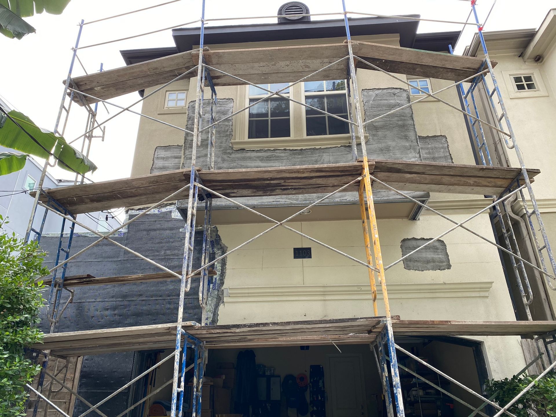 A house is being remodeled with scaffolding around it.