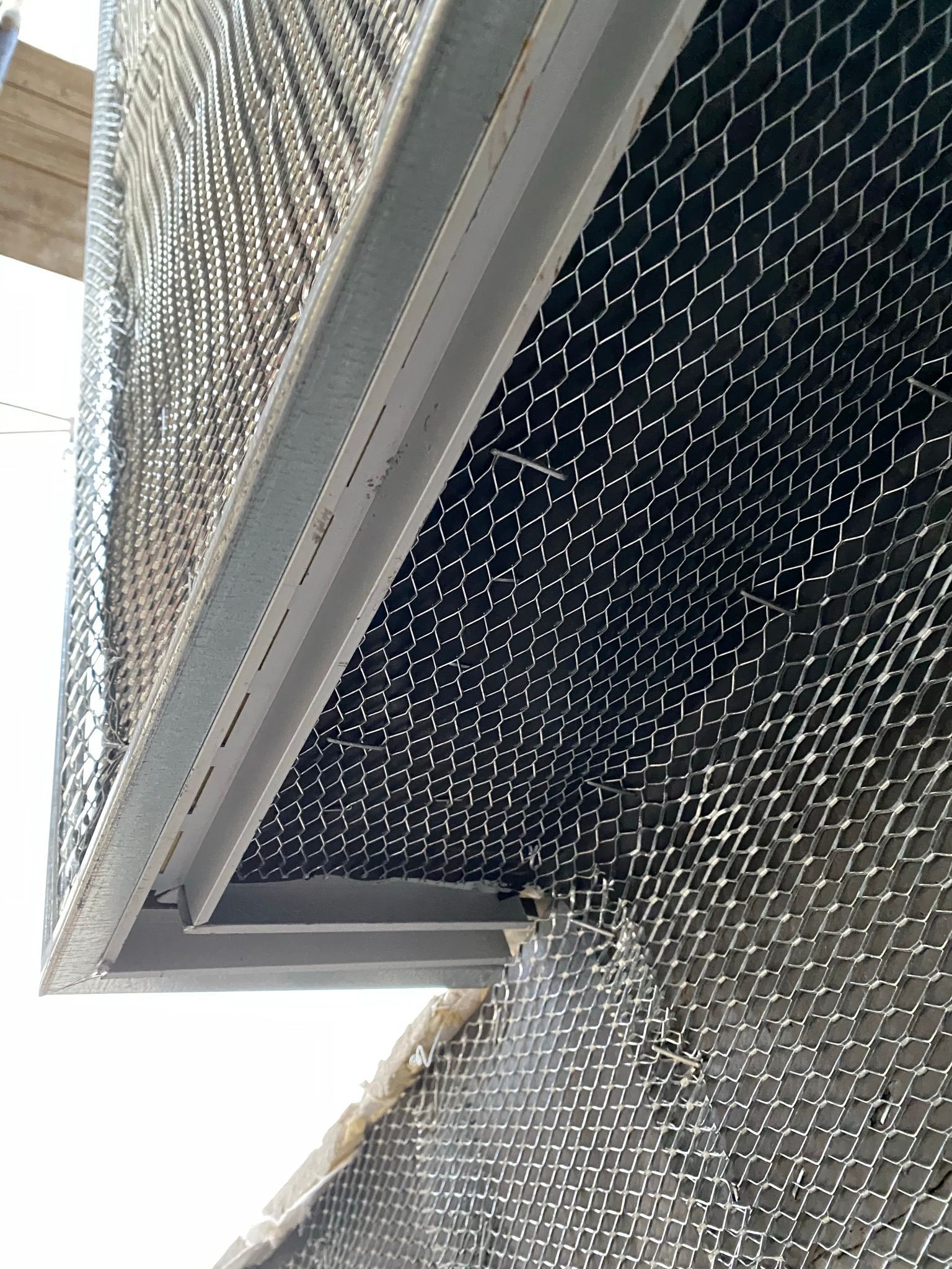 A close up of a metal grille on a wall.