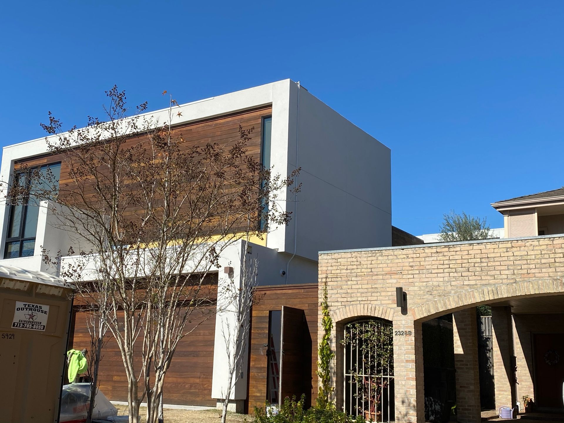A large house with a brick building in front of it