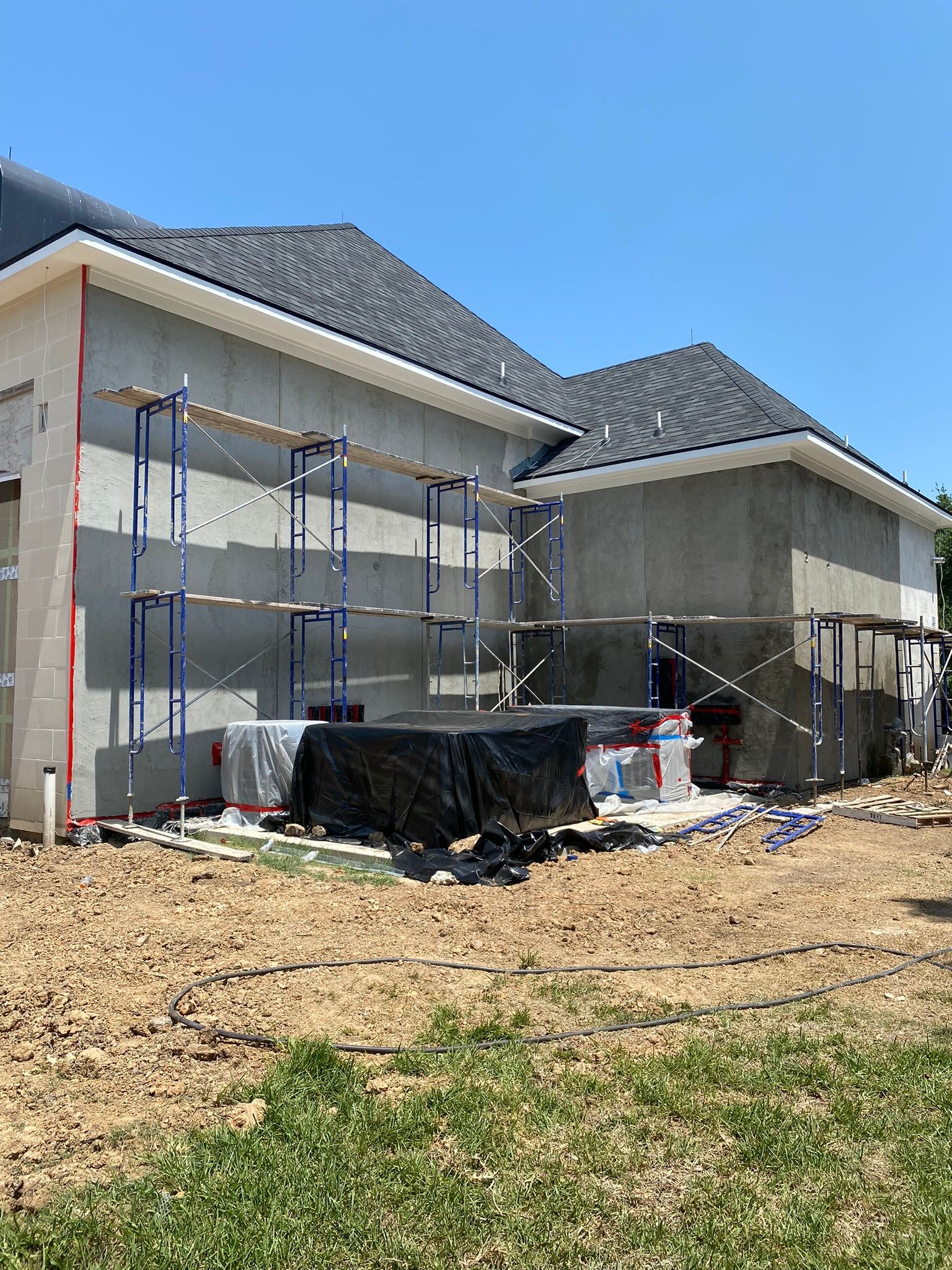 A house is being built with scaffolding on the side of it.