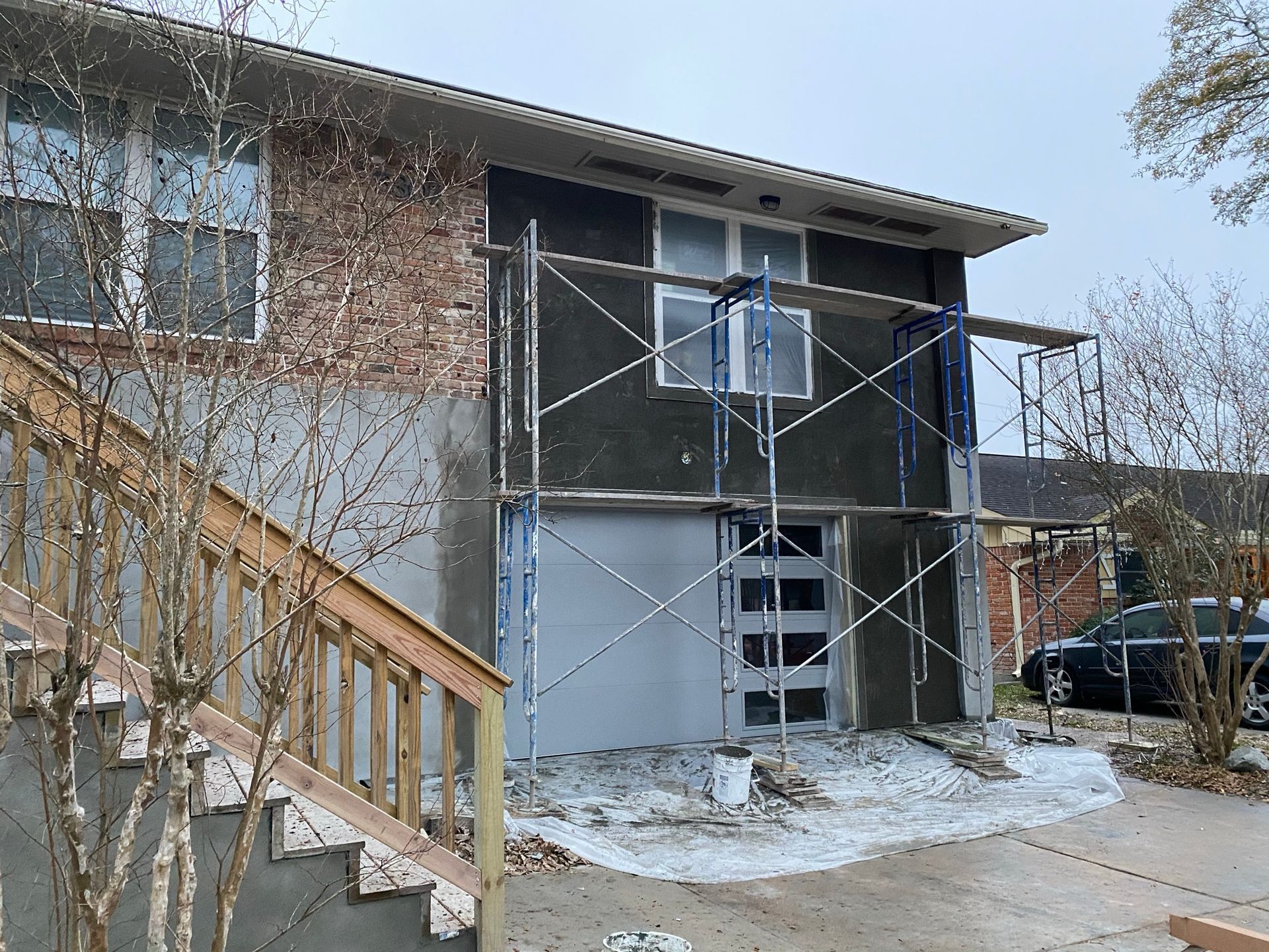 A house is being painted with scaffolding in front of it.
