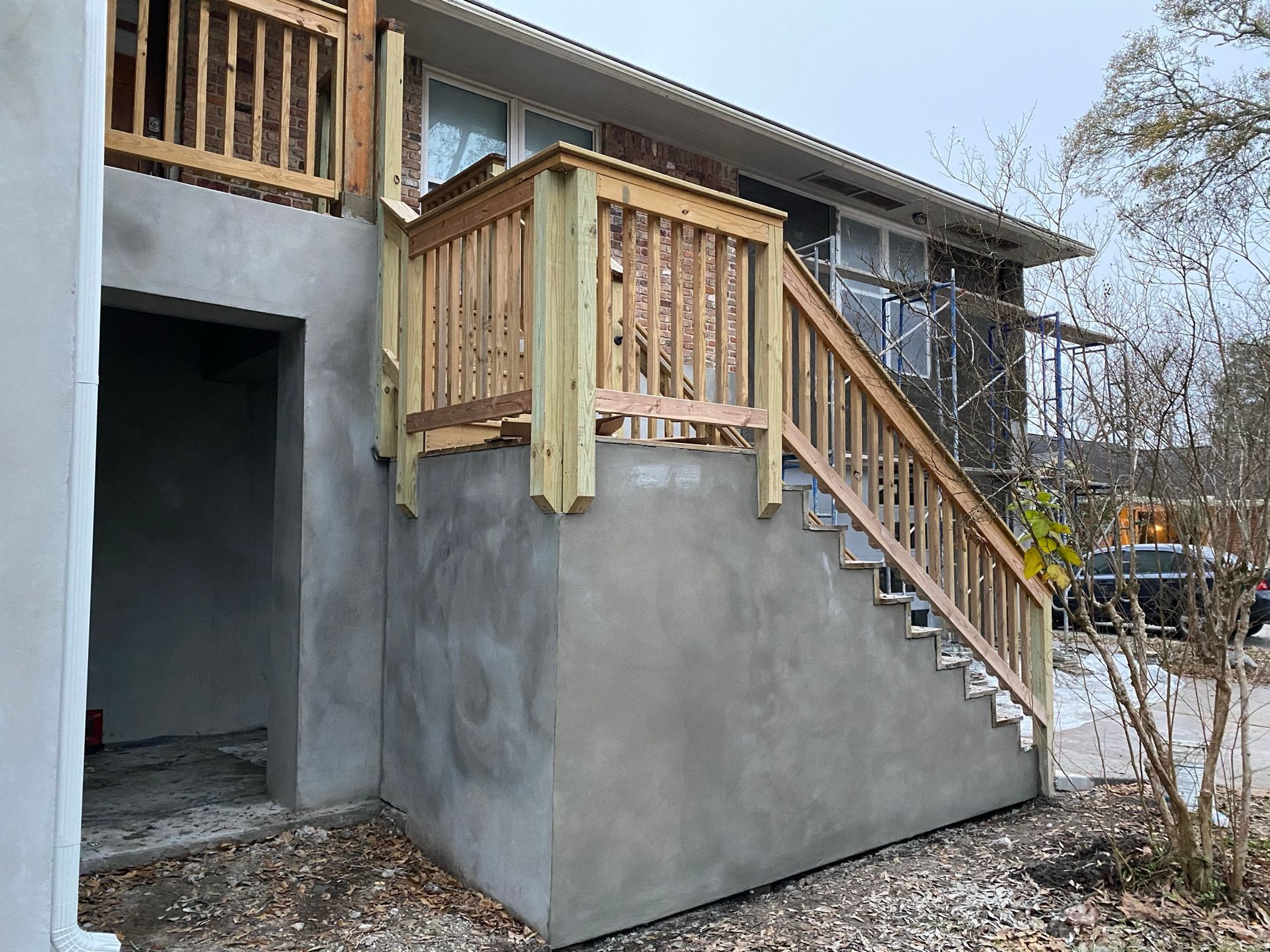 A house with a wooden deck and stairs on the side