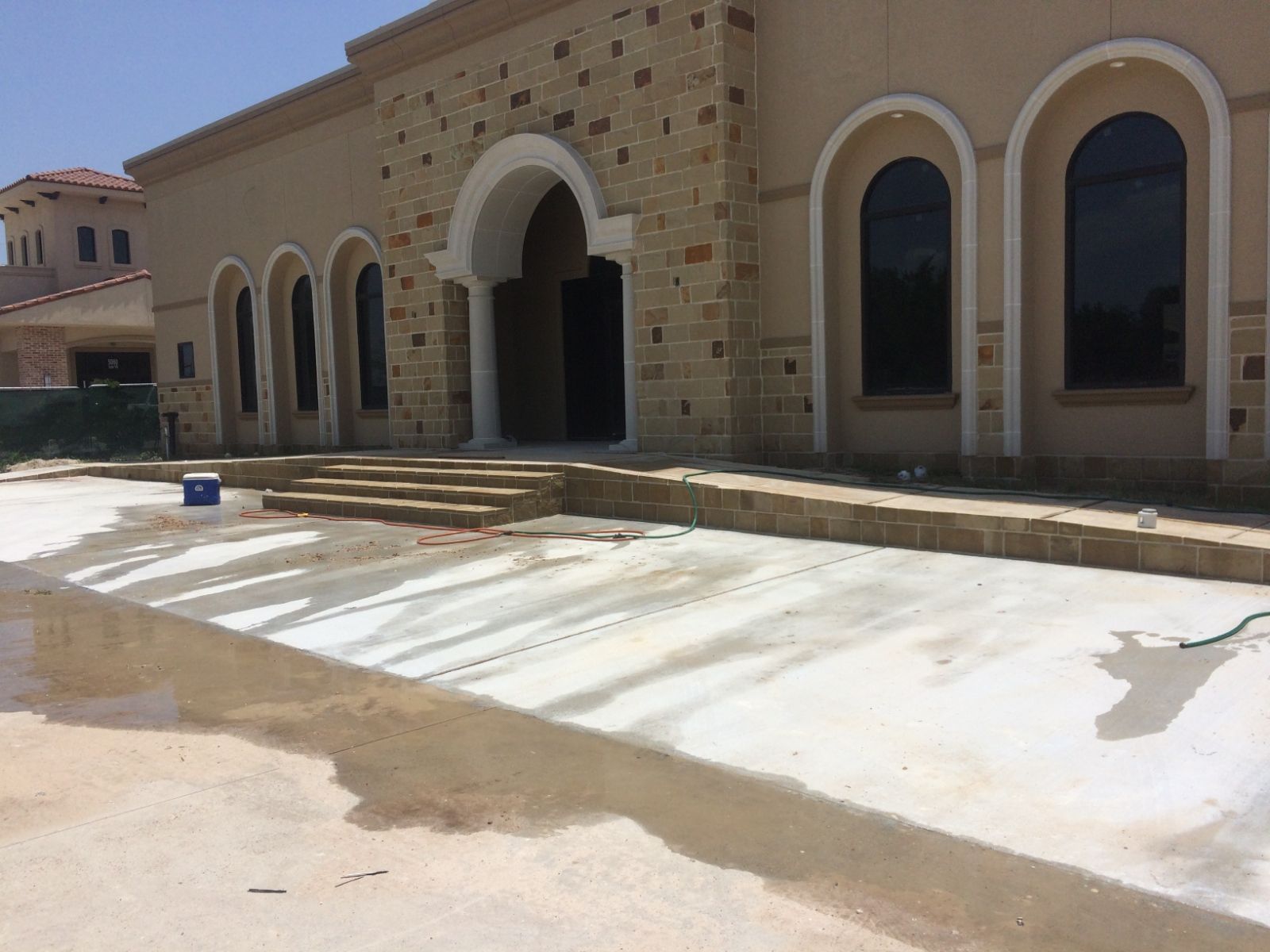 A large building with arched windows is under construction