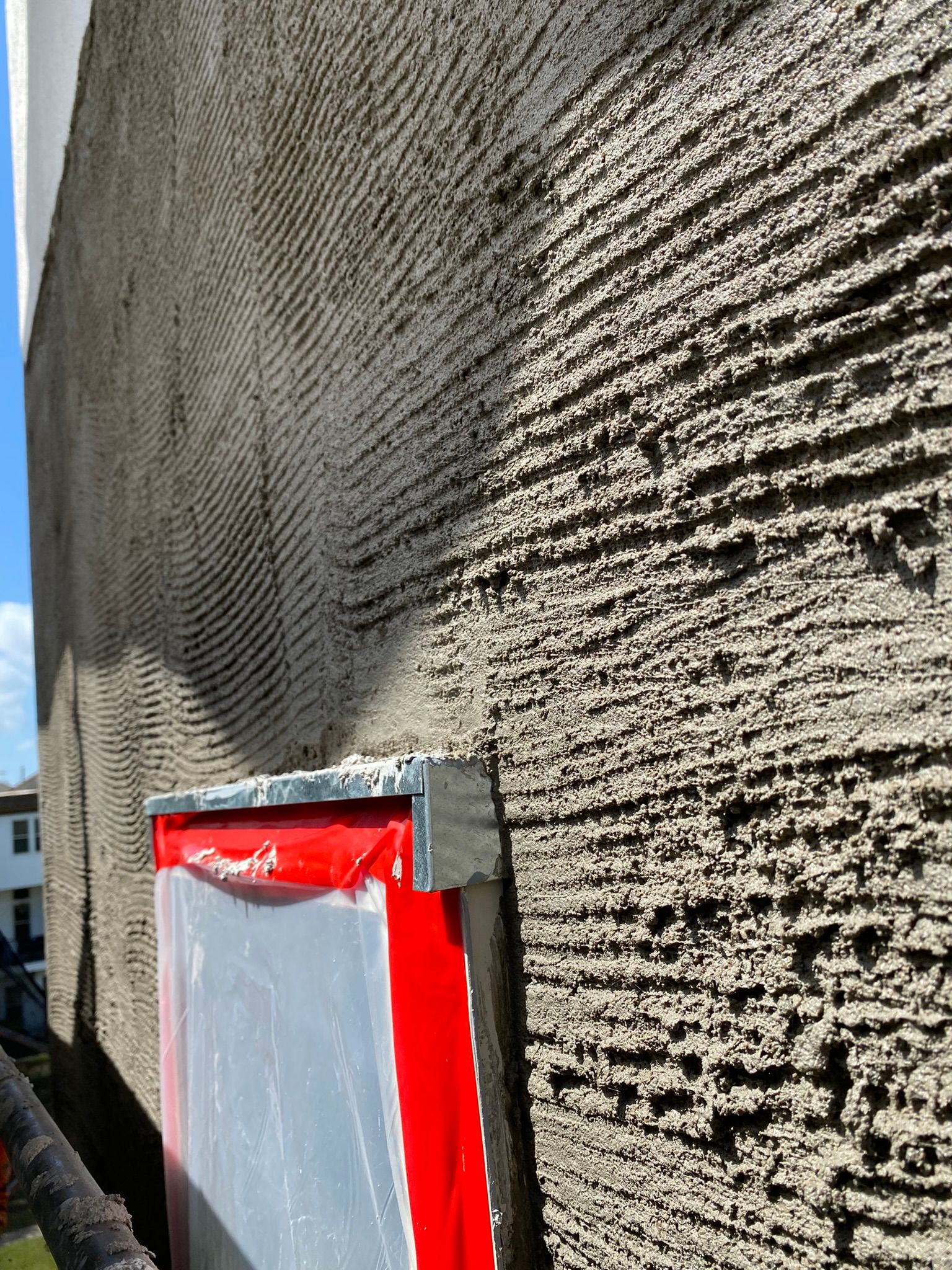 A close up of a concrete wall with a red frame on it.