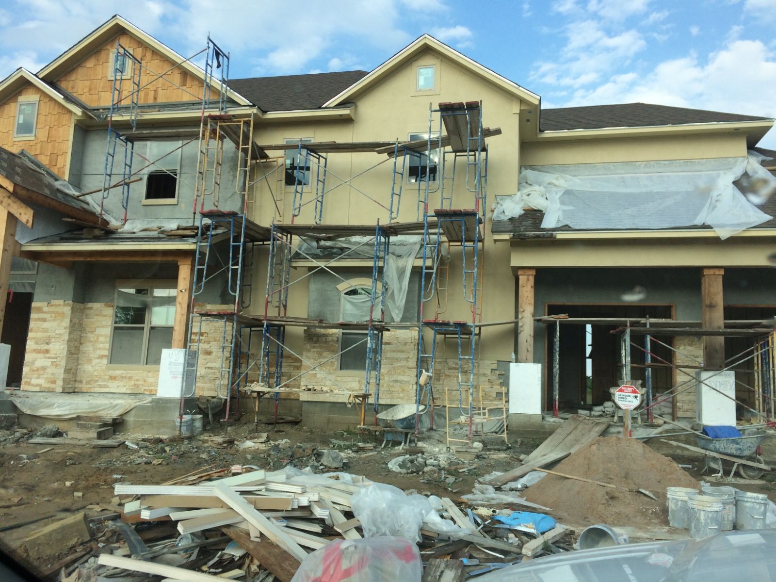 A large house is being built with scaffolding around it.