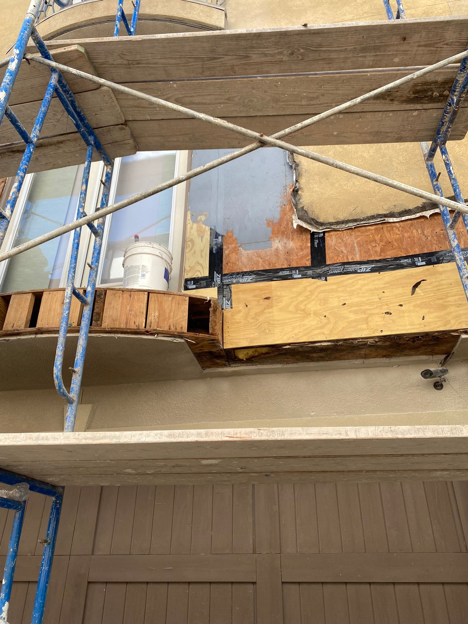 A wooden scaffolding is sitting on top of a building.