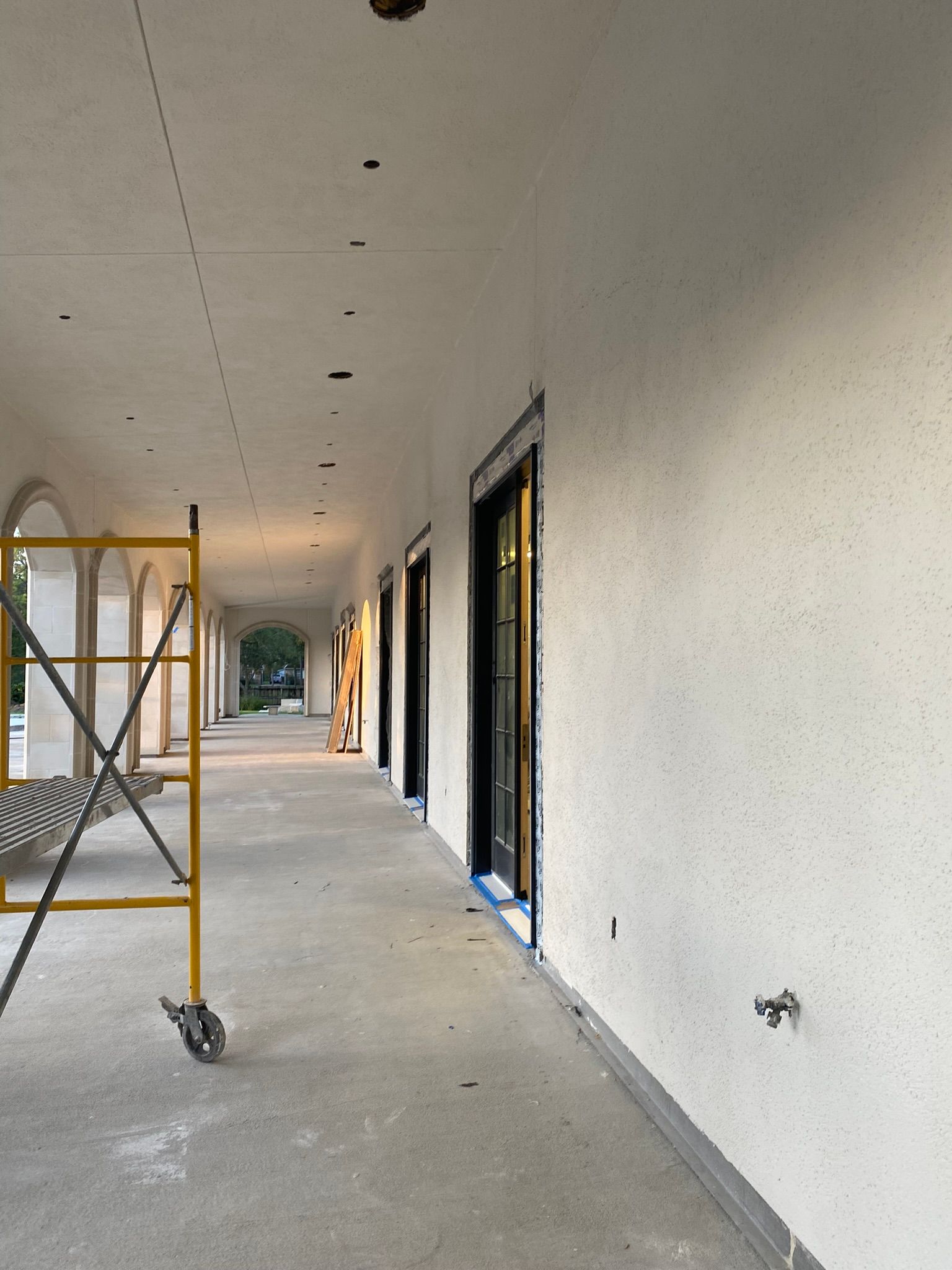 A long hallway with a yellow scaffolding in the middle