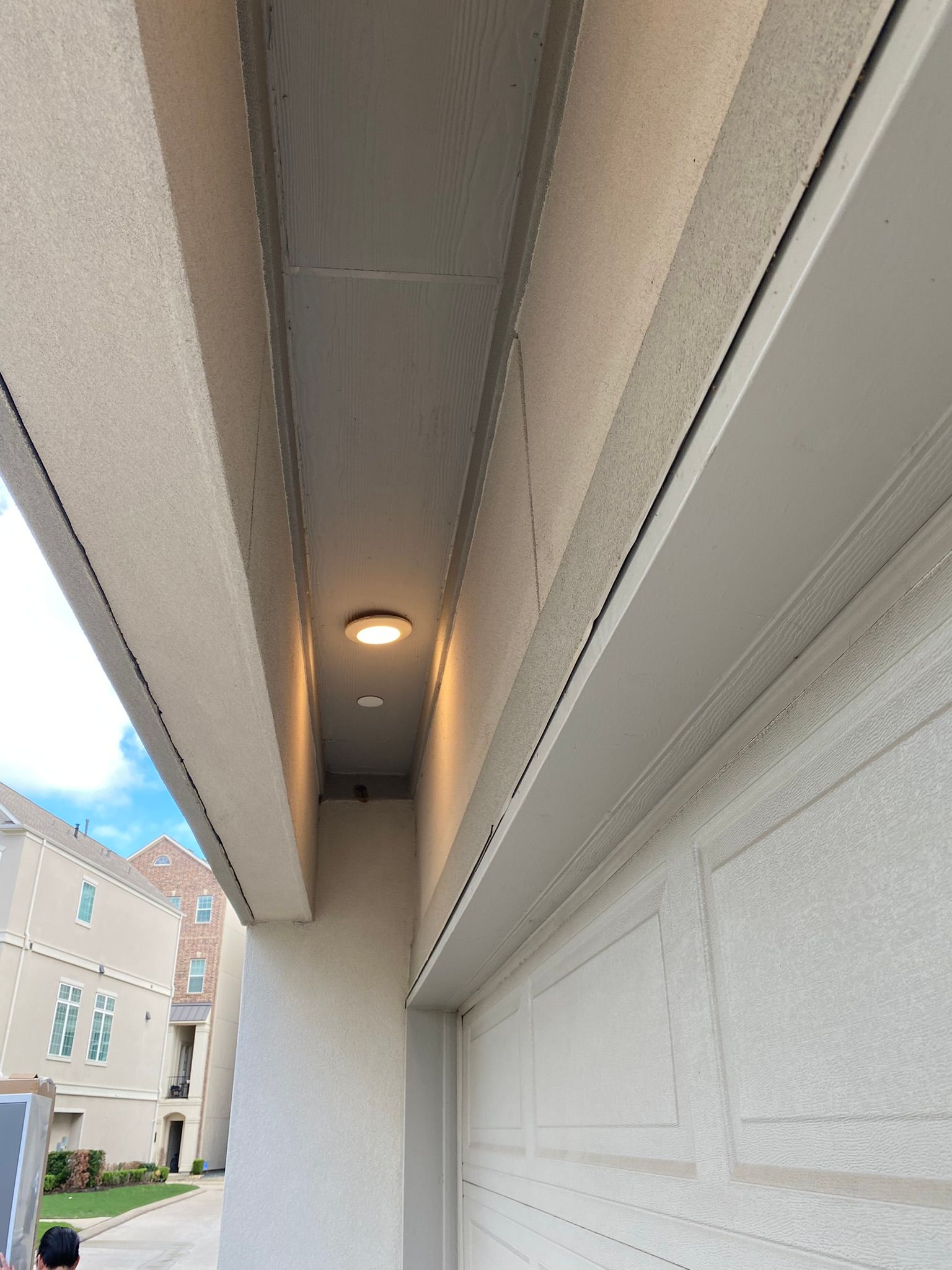 There is a light on the ceiling of the garage door.