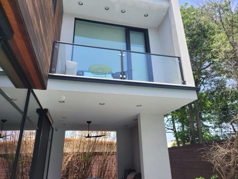 A house with a balcony and a ceiling fan