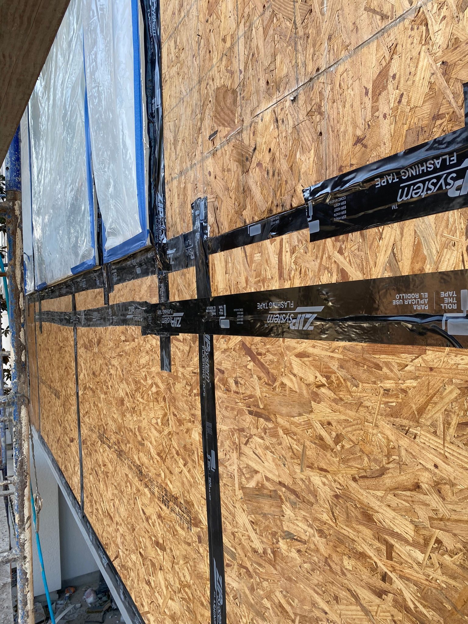 A close up of a wall with a lot of tape on it.
