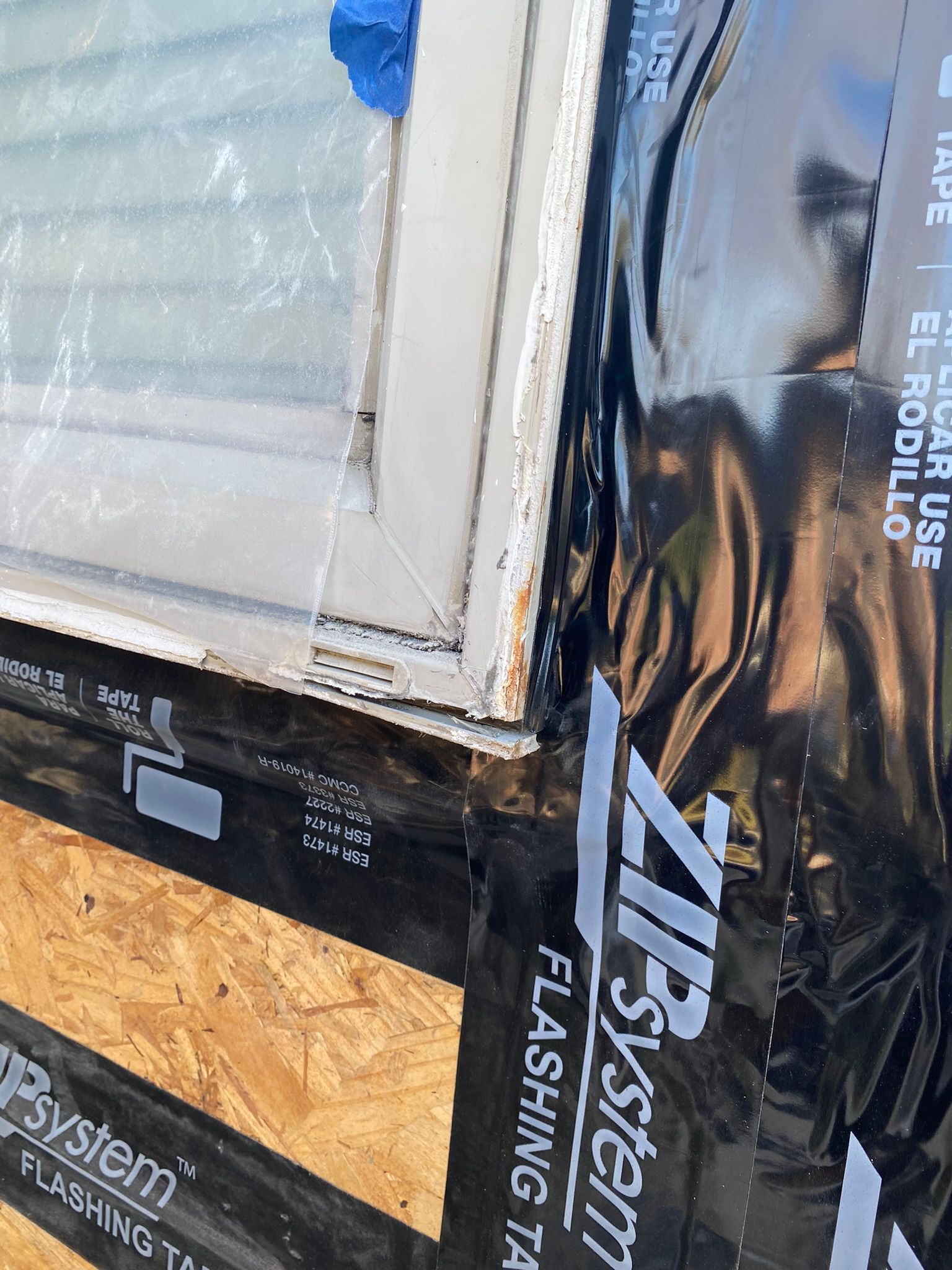 A close up of a zip system flashing tape on a window