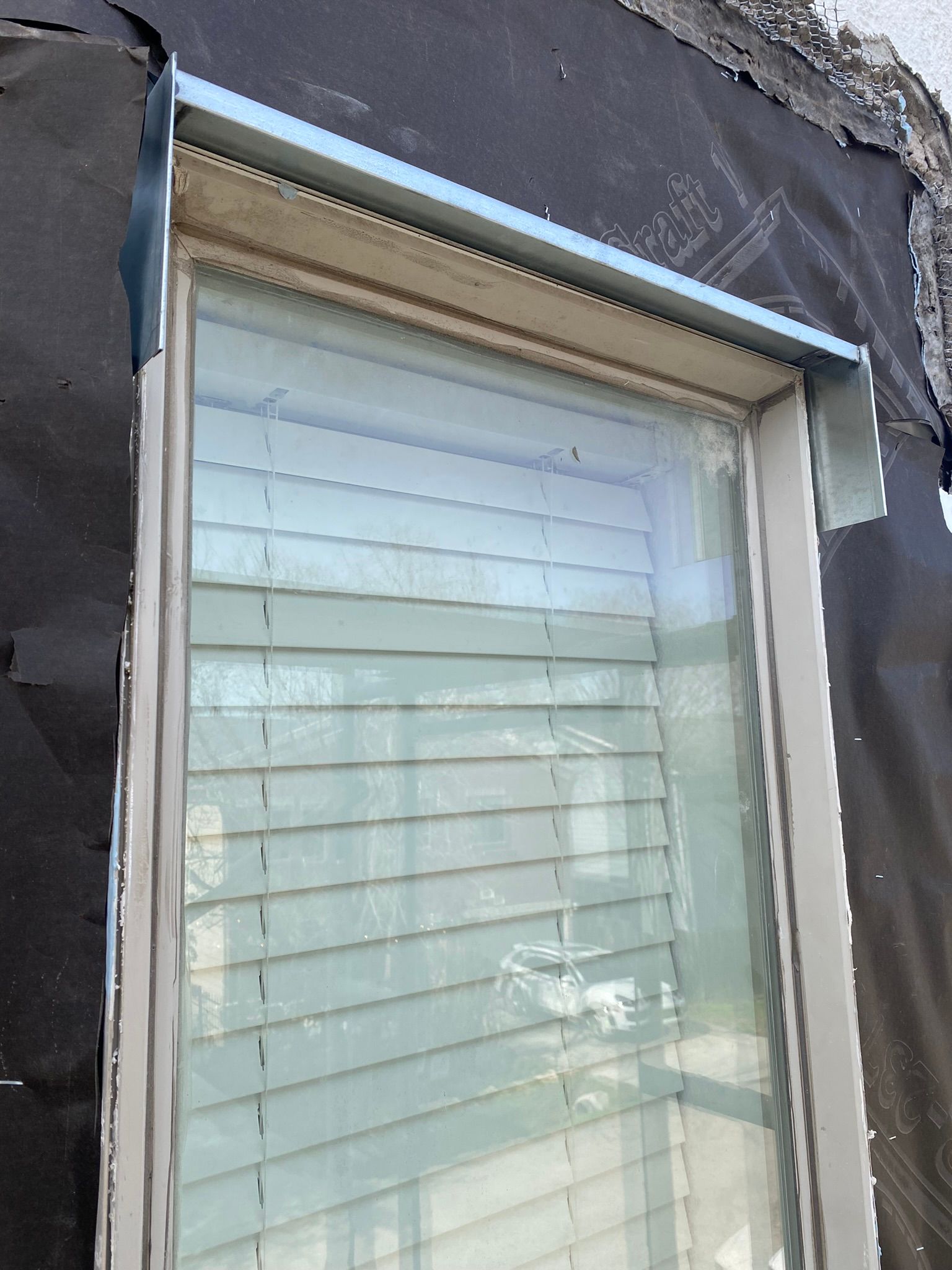 A close up of a window with blinds on it.