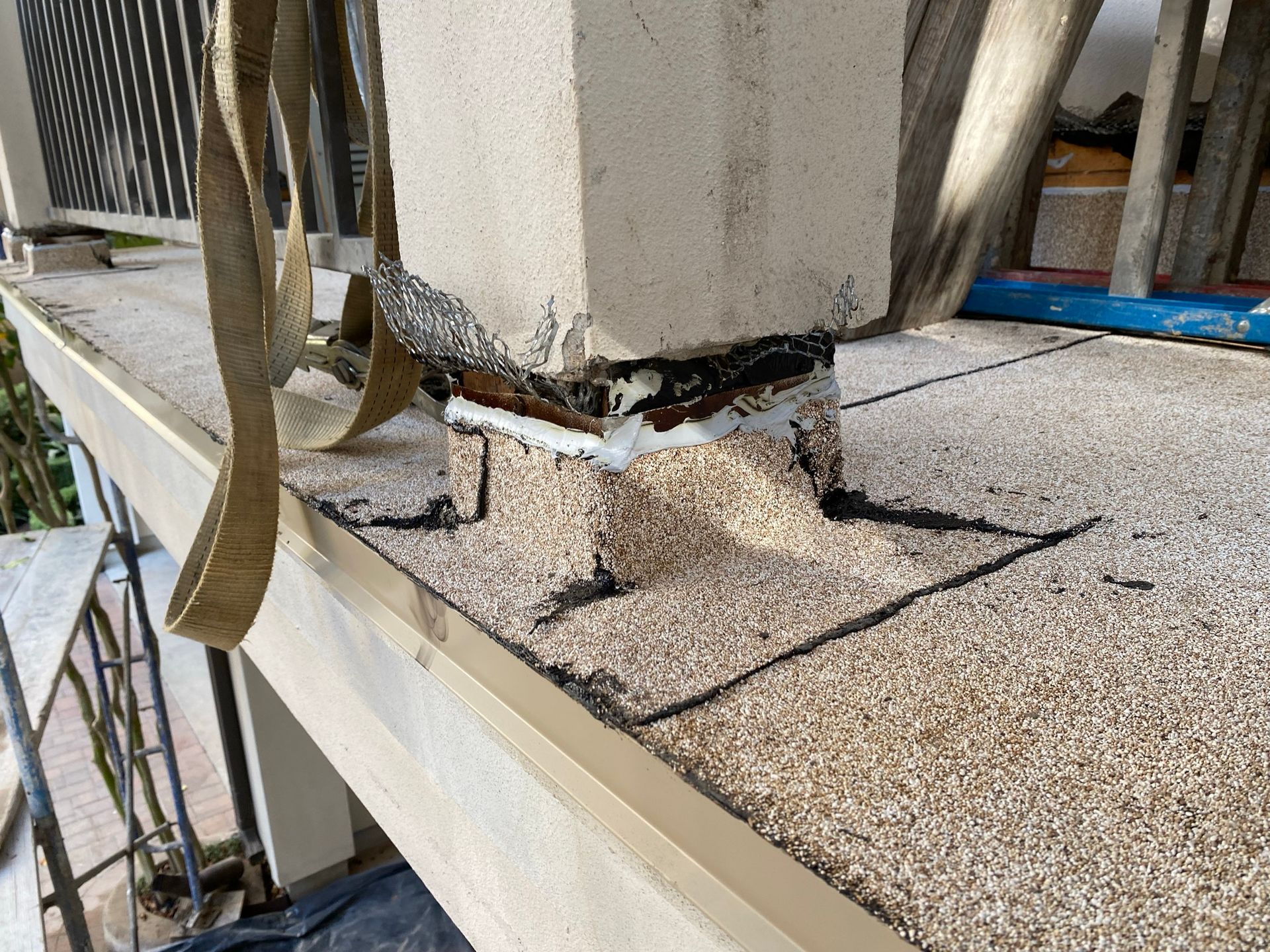 A concrete pillar is sitting on top of a tiled floor.
