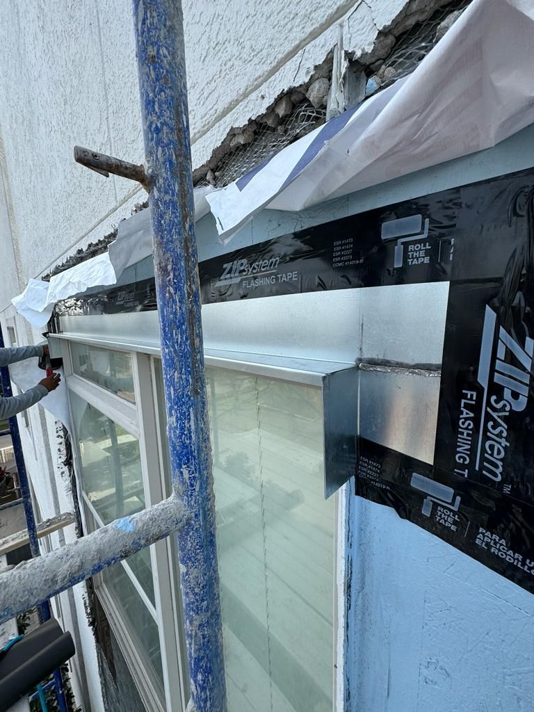 A window is being installed on the side of a building.
