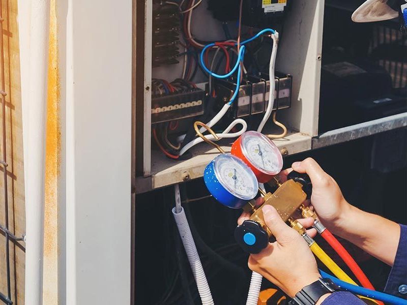 HVAC technician checking new air conditioner