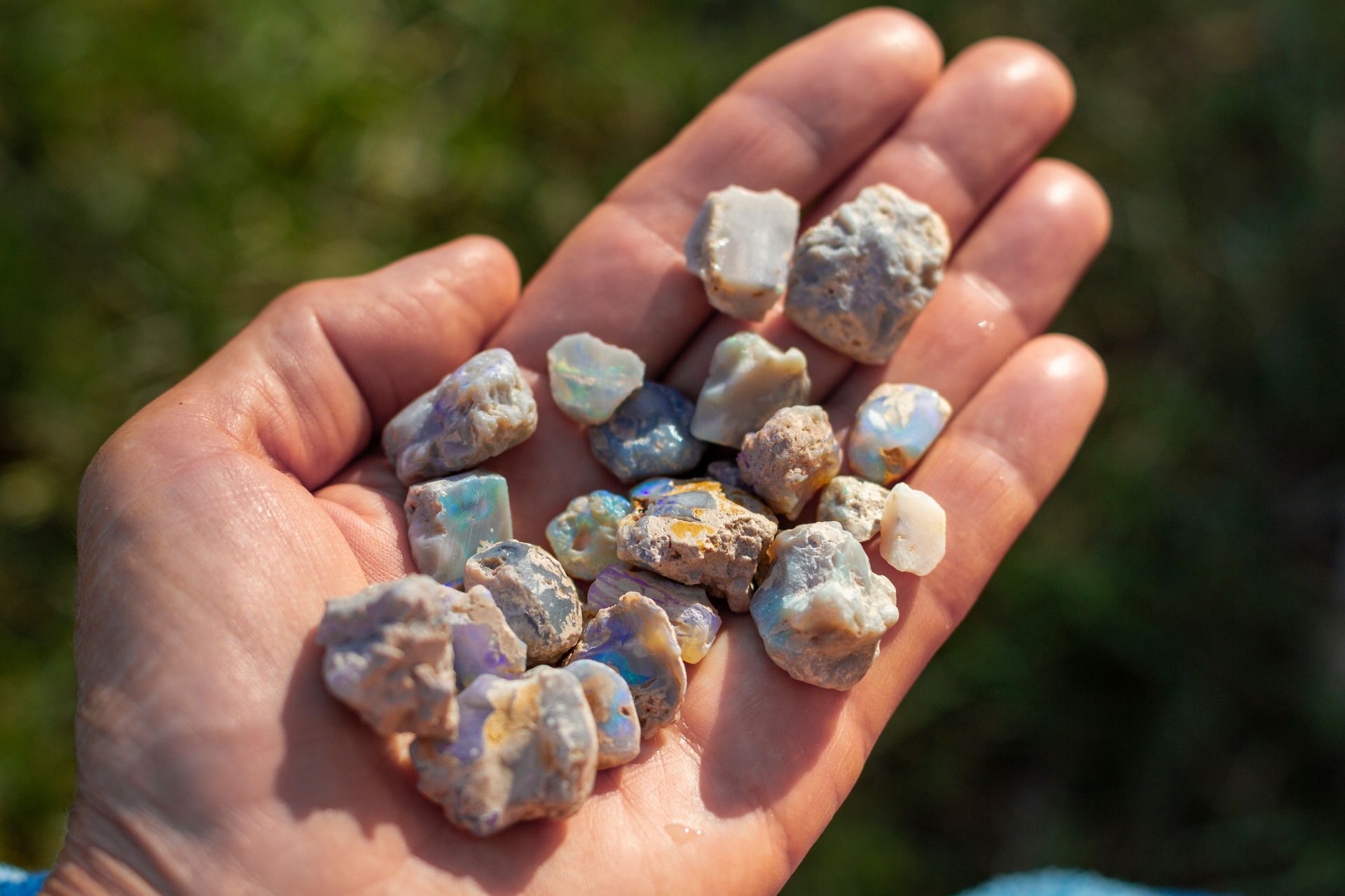 A person is holding a pile of rocks in their hand.