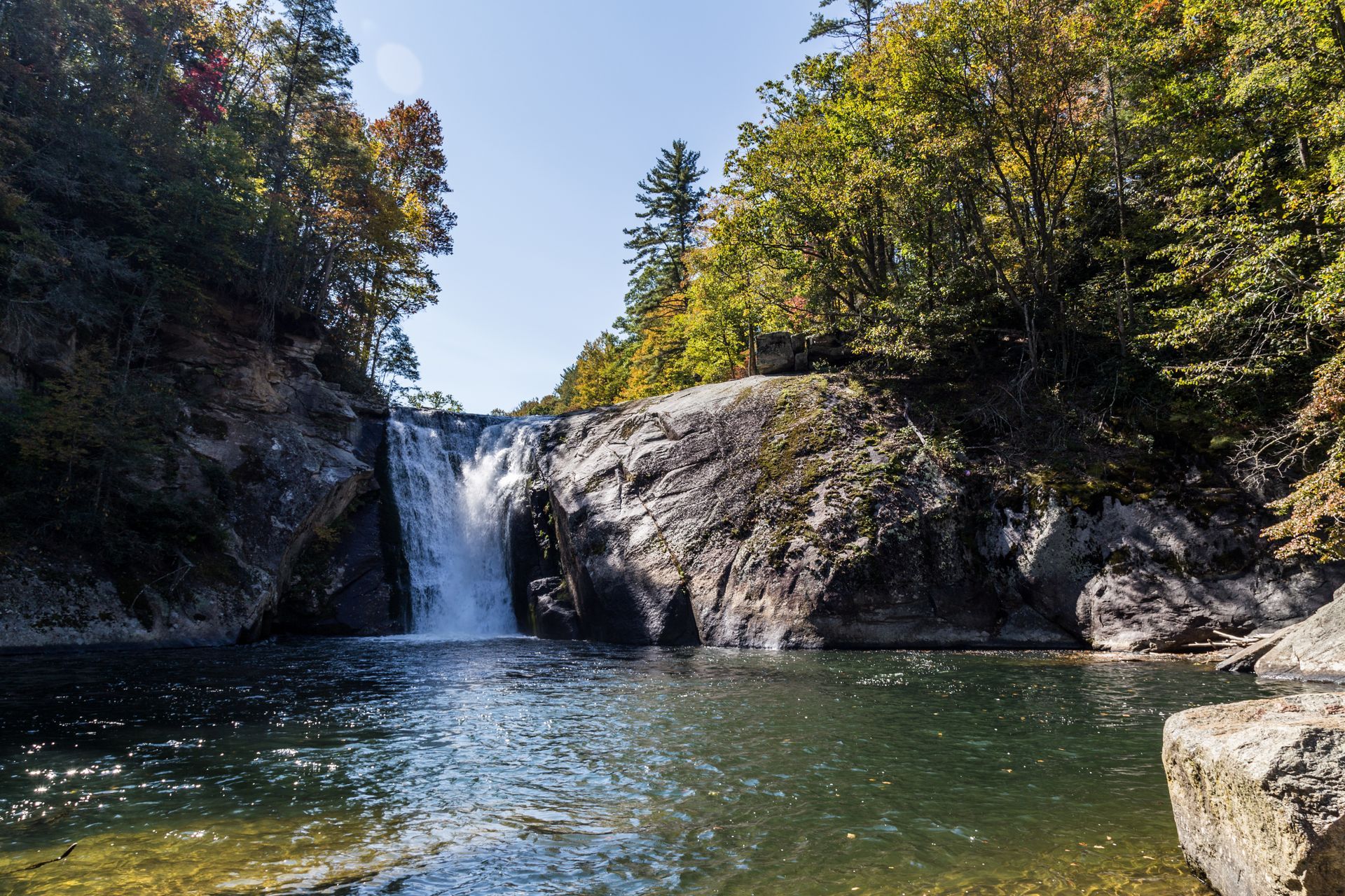 scenic shot of a waterfall cascading into the water
