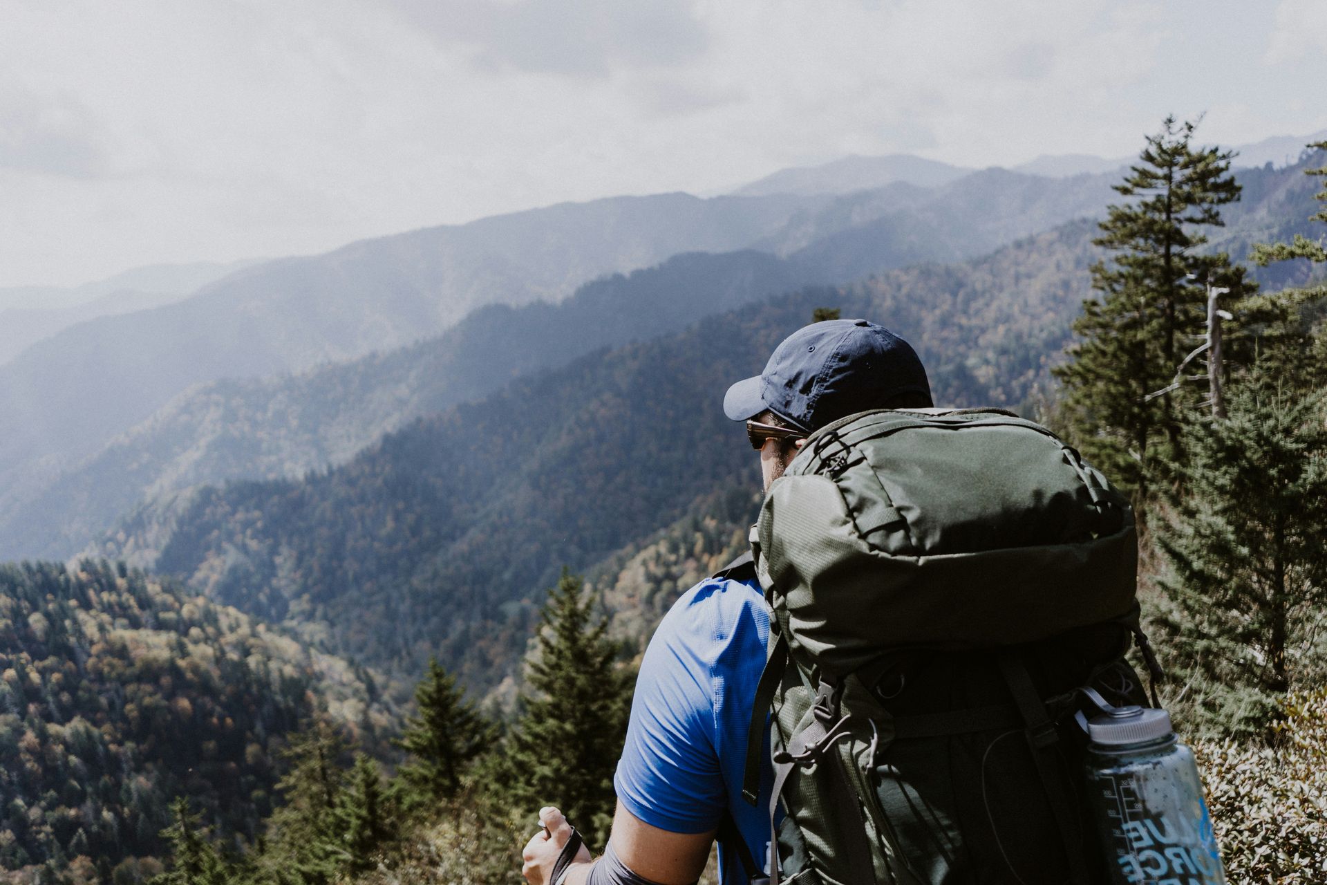 man hiking in the mountains with a backpack on