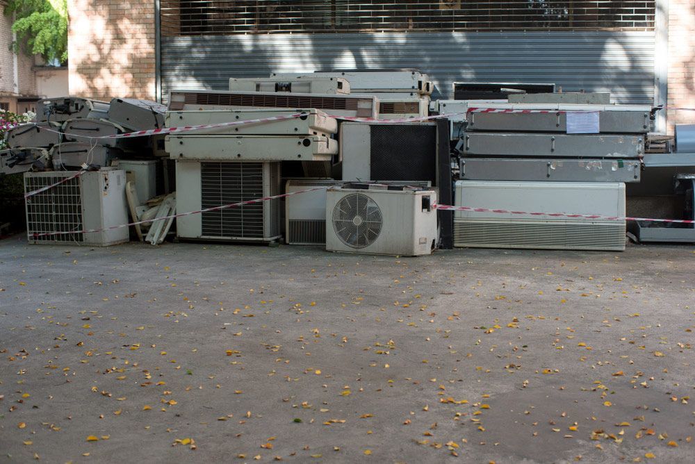 Multiple air conditioning units stacked for recycling — Professional Scrap Metal Recycling in Palmerston, NT