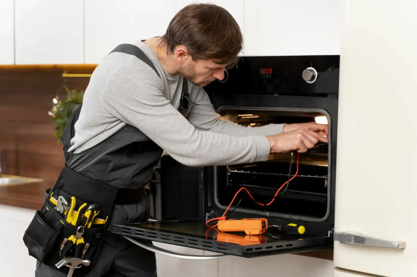 Worker fixing the oven