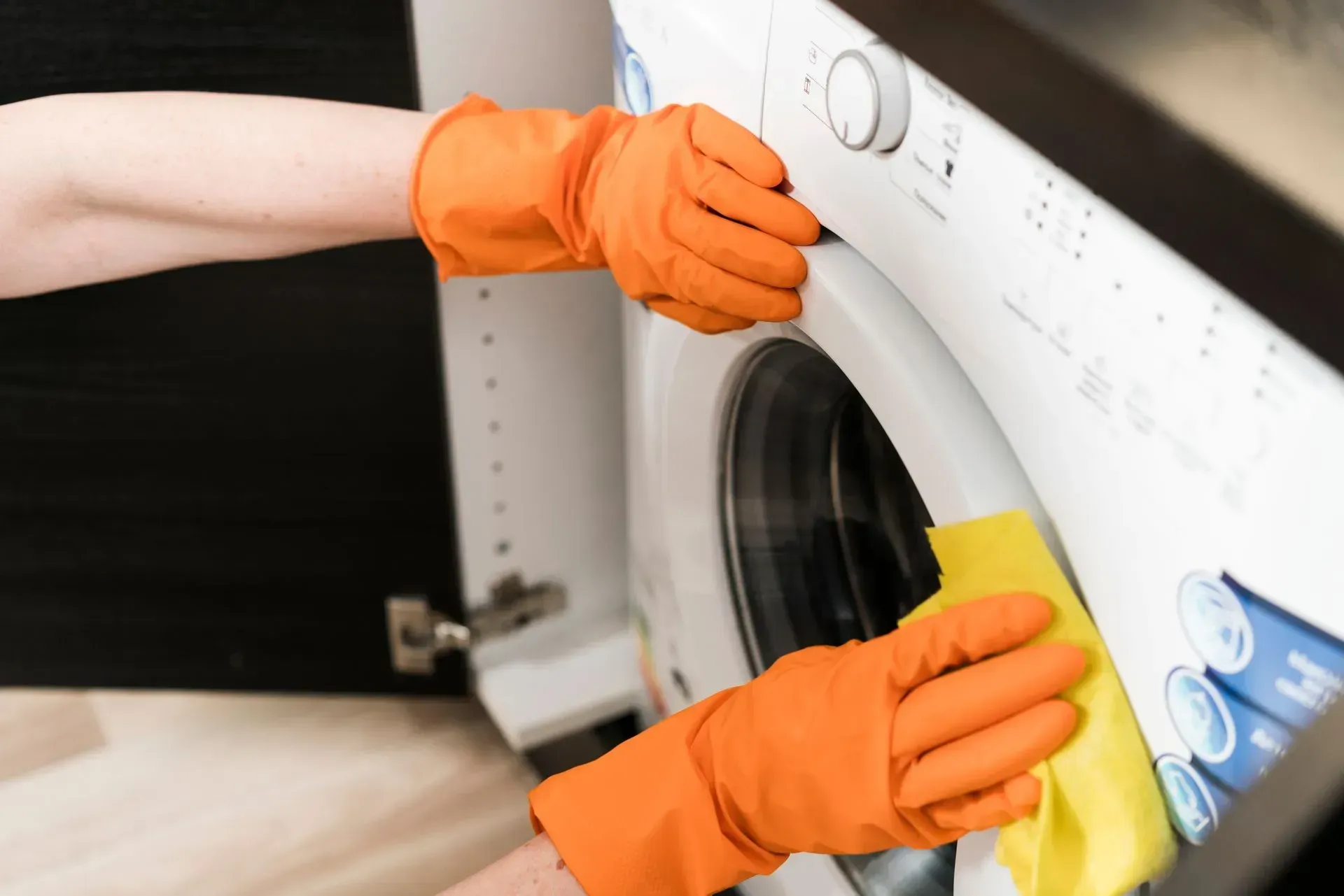 Woman cleaning washing machine