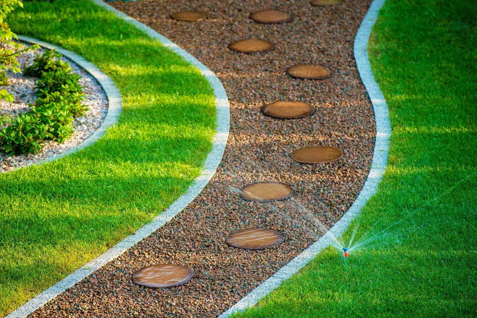Yellow lawn mower kicking up dirt on a grassy slope