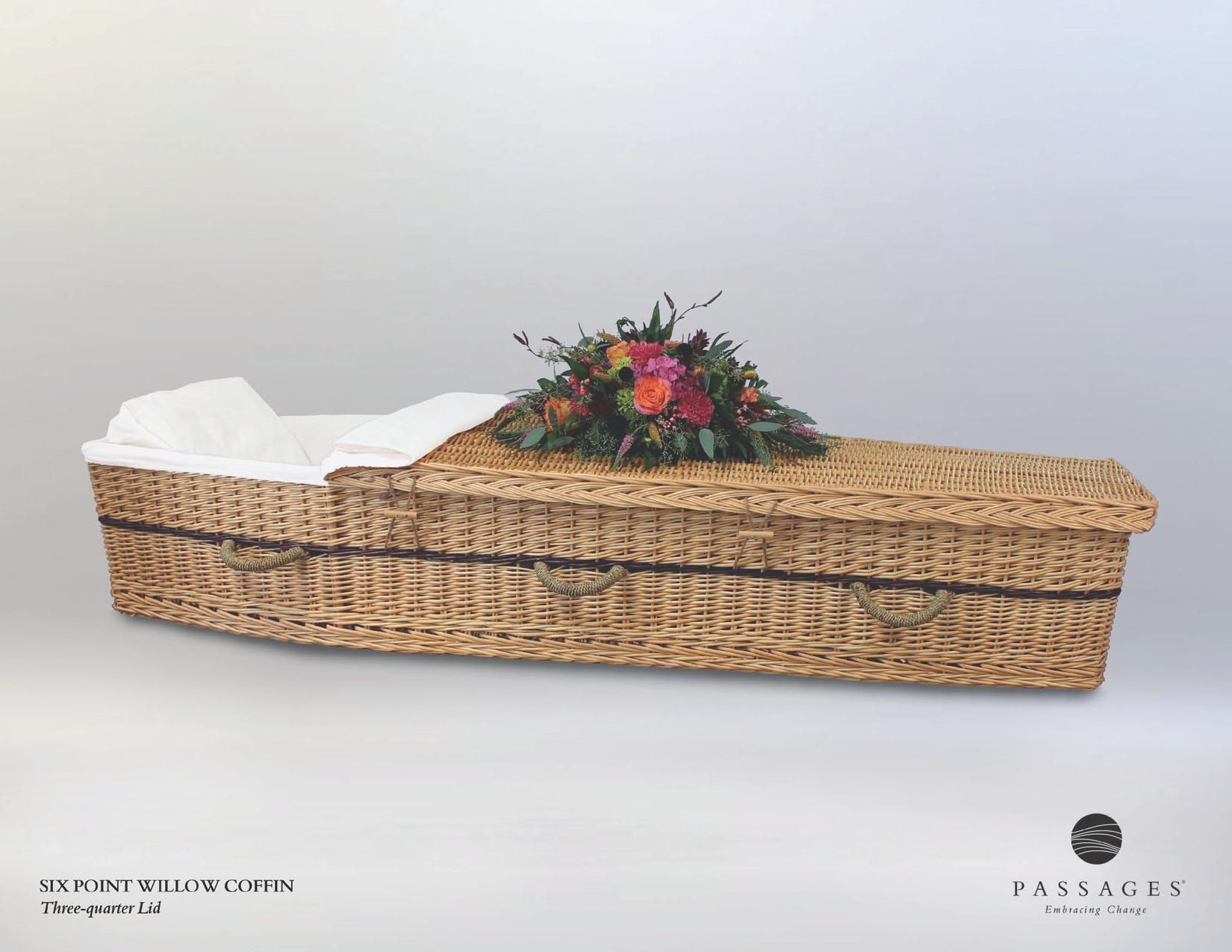 Woven coffin with floral arrangement on a white background.