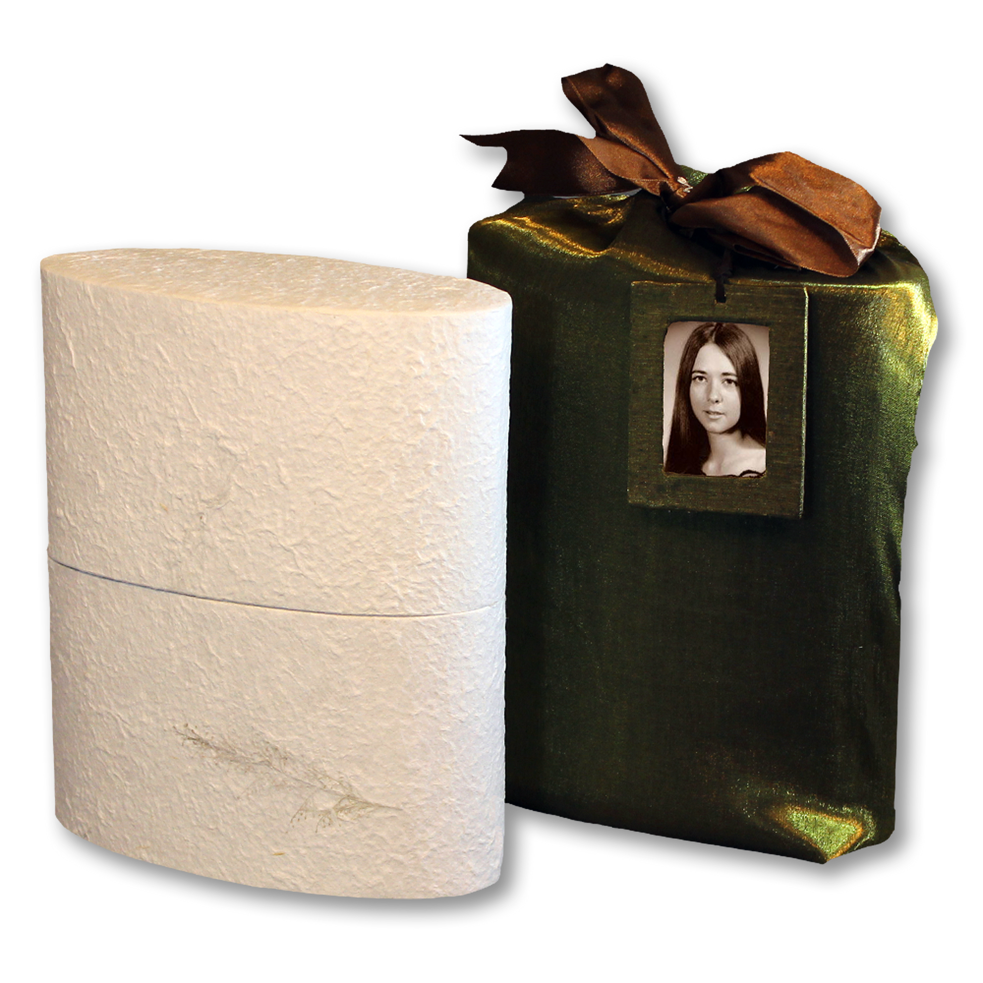 Oval white urn next to a wrapped green gift. Gift has a photo tag and brown bow.