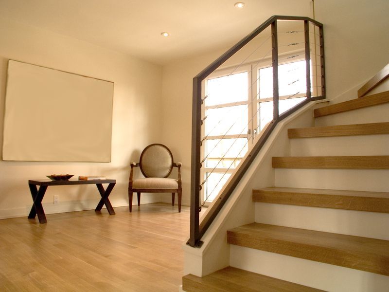 Refinished light oak plank flooring and a staircase with oak flooring