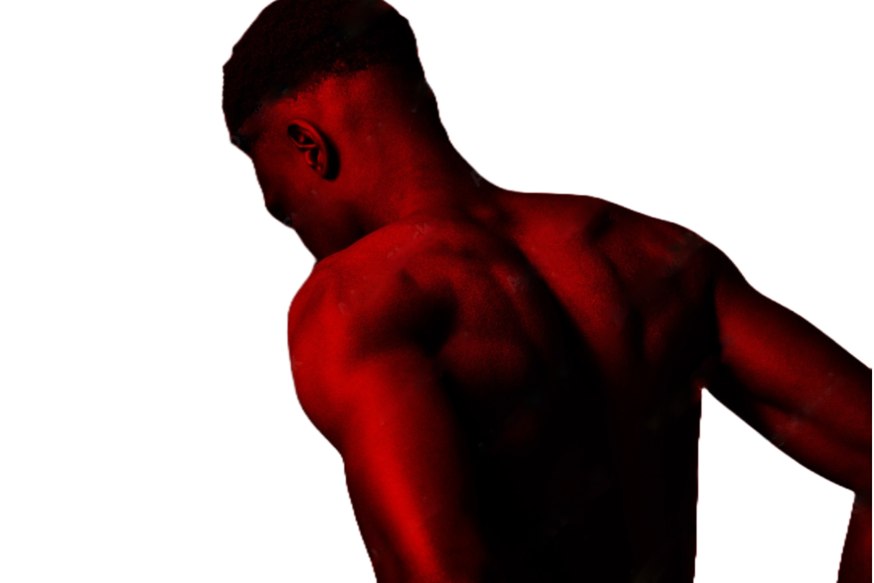 A muscular man with dark skin and a faded haircut bends backward, bathed in red light.