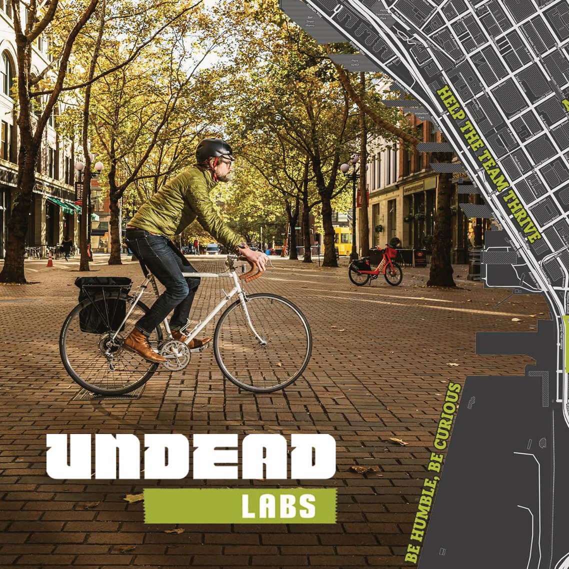 person on bike on one side and the Undead Labs logo with a map on the other side
