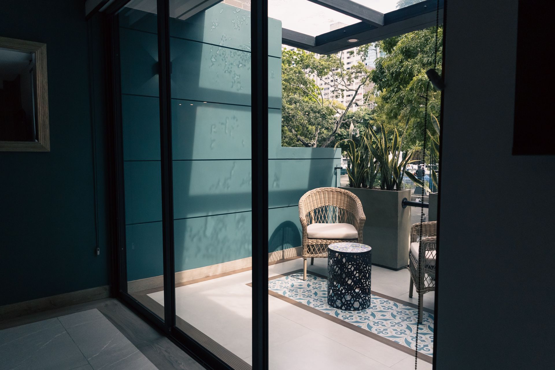 A room with a sliding glass door leading to a balcony
