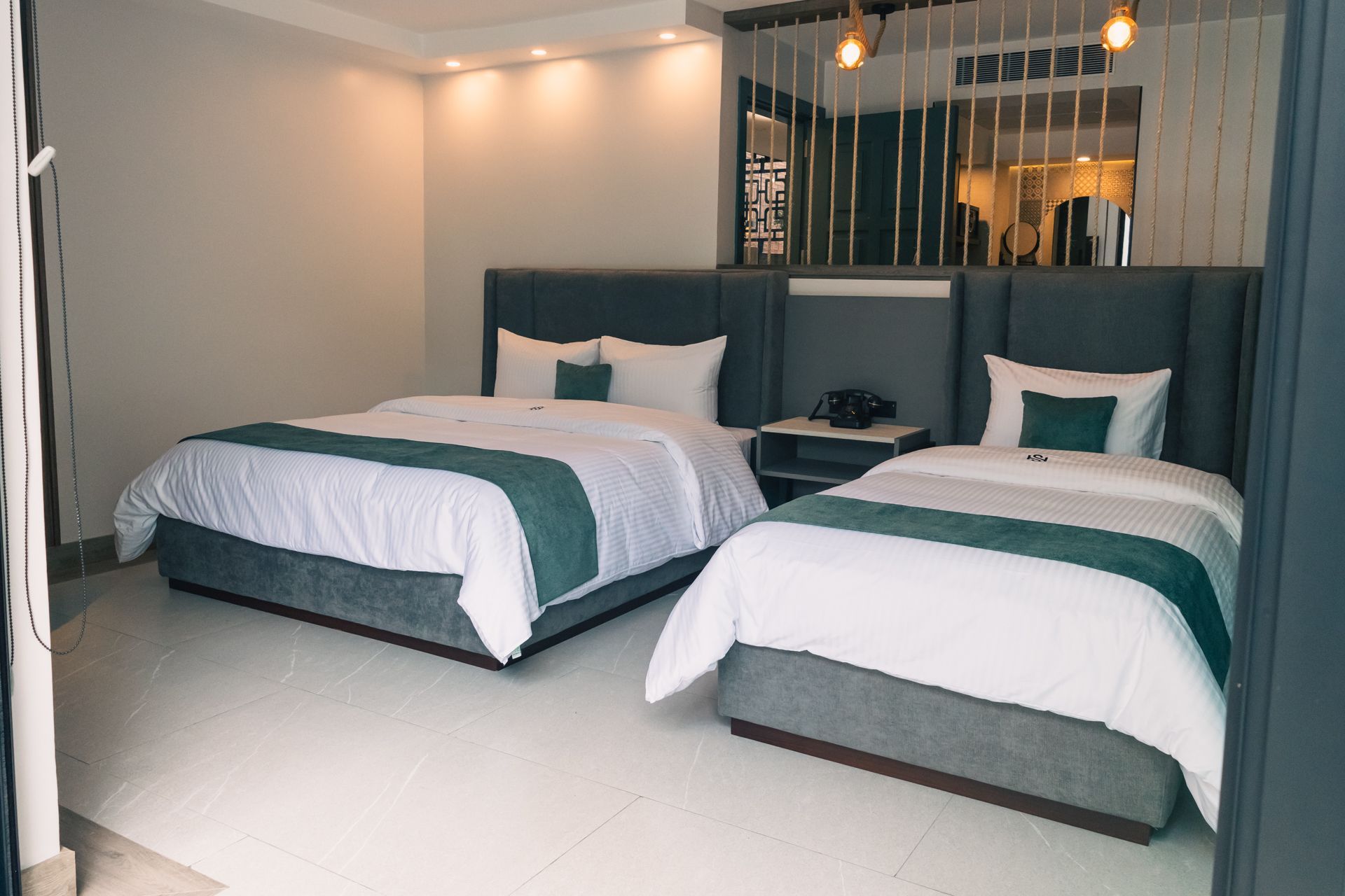 A hotel room with two beds and a mirror.