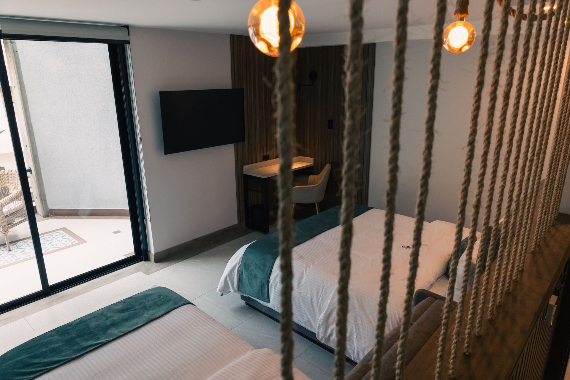 A hotel room with two beds , a desk and a television.