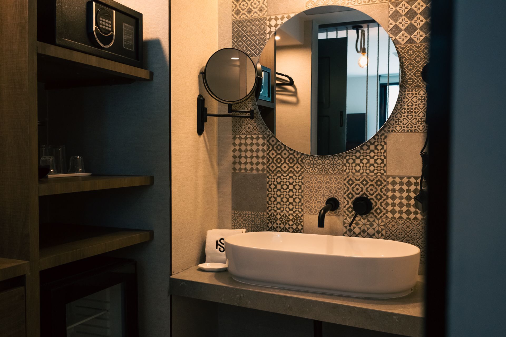 A bathroom with a sink , mirror and radio.